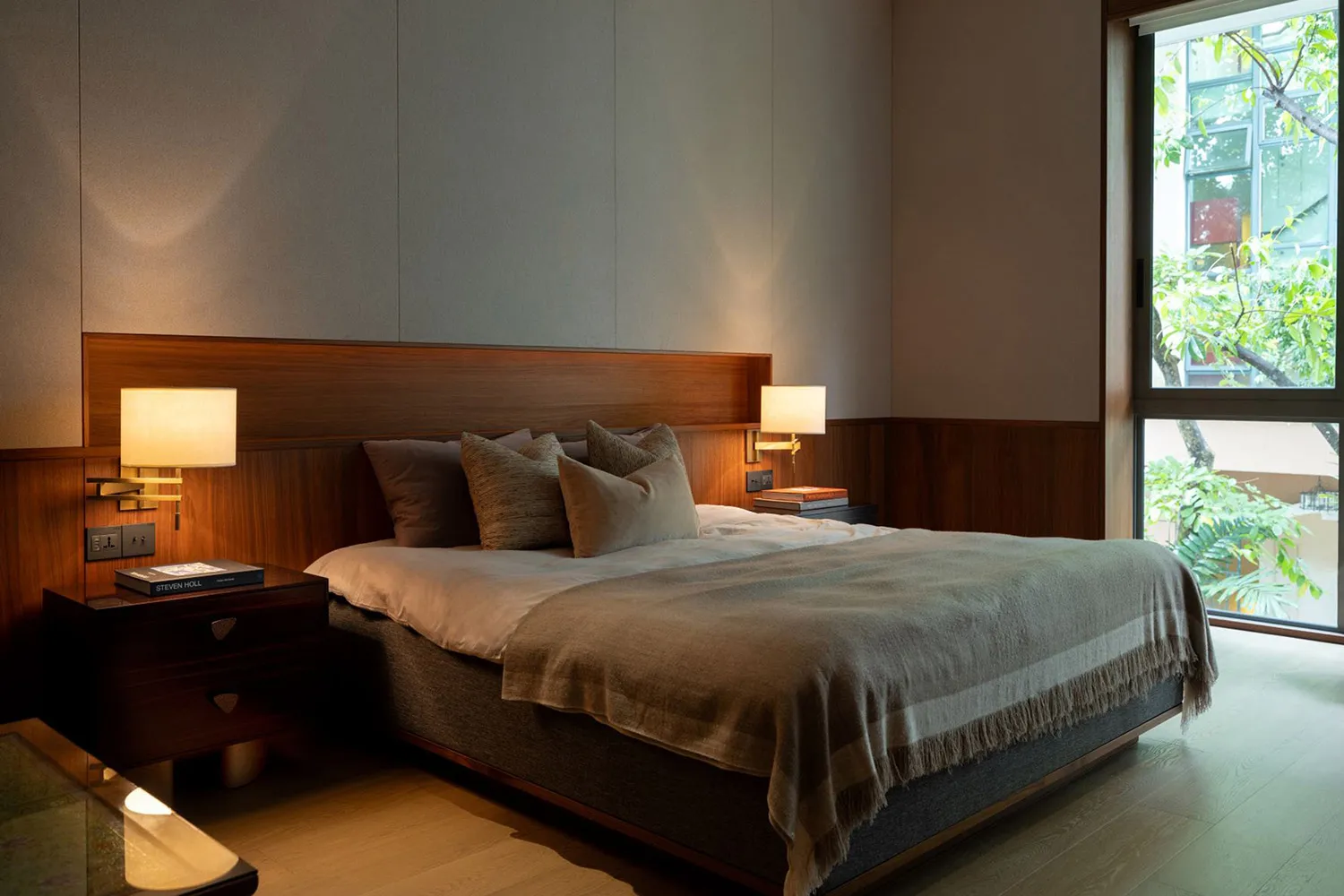 A modern bedroom with a Scandinavian slate wall and wooden furniture.