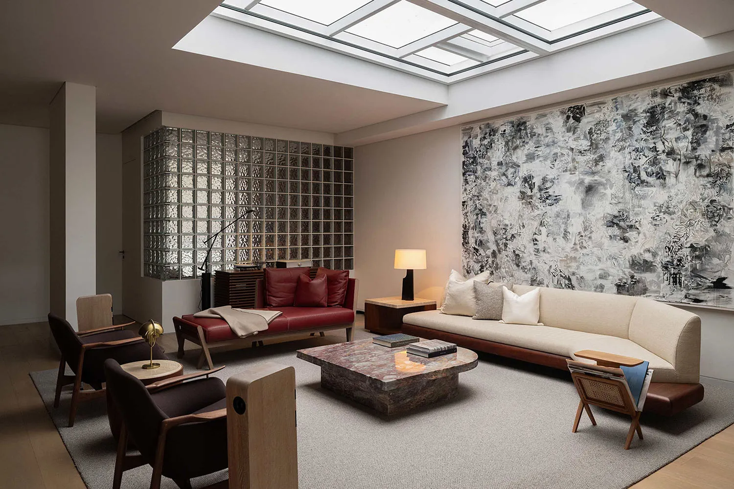 Modern living room featuring a marble coffee table surrounded by contemporary furniture and large abstract artwork on the wal