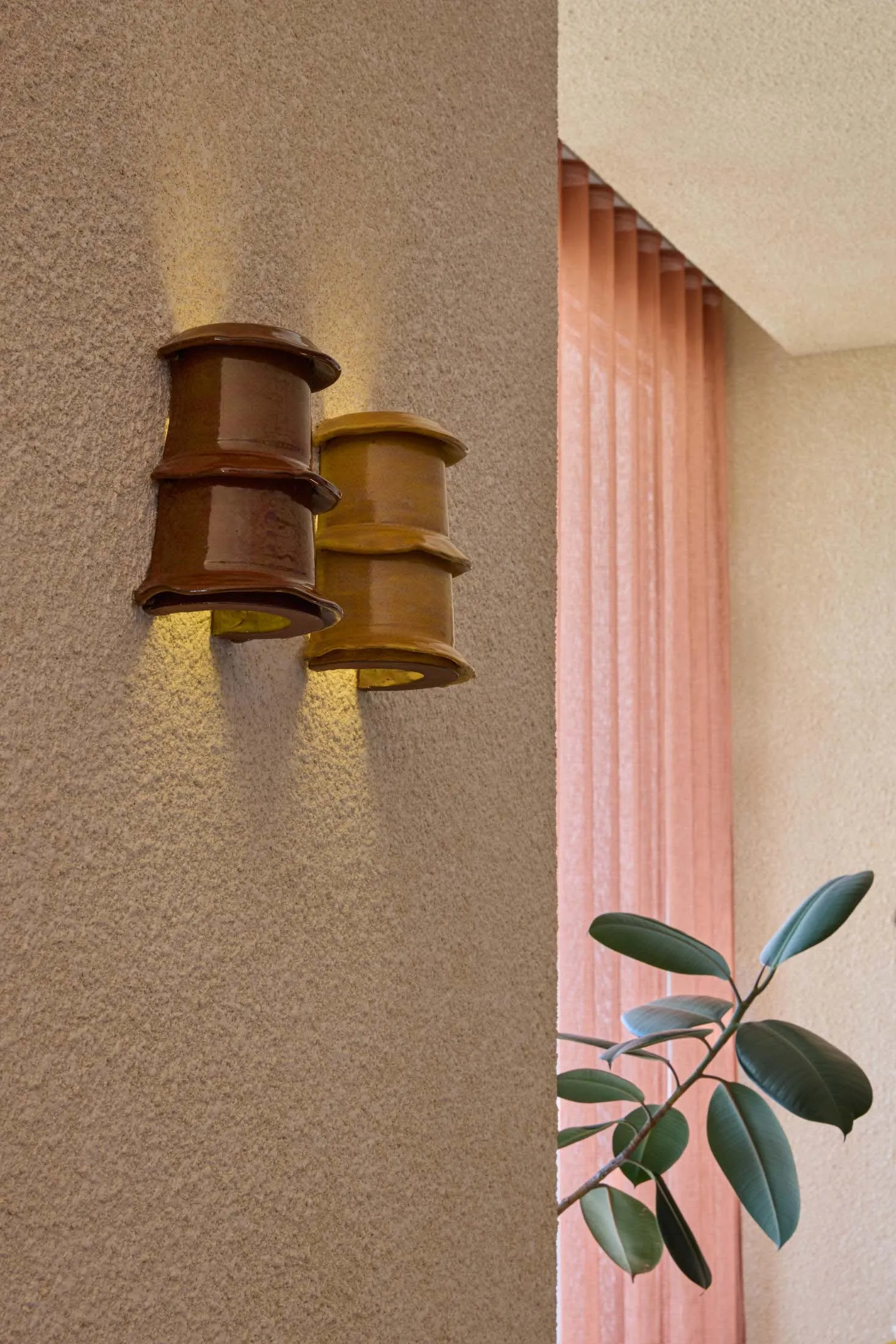 A ceramic wall light fixture with a rustic appearance.
