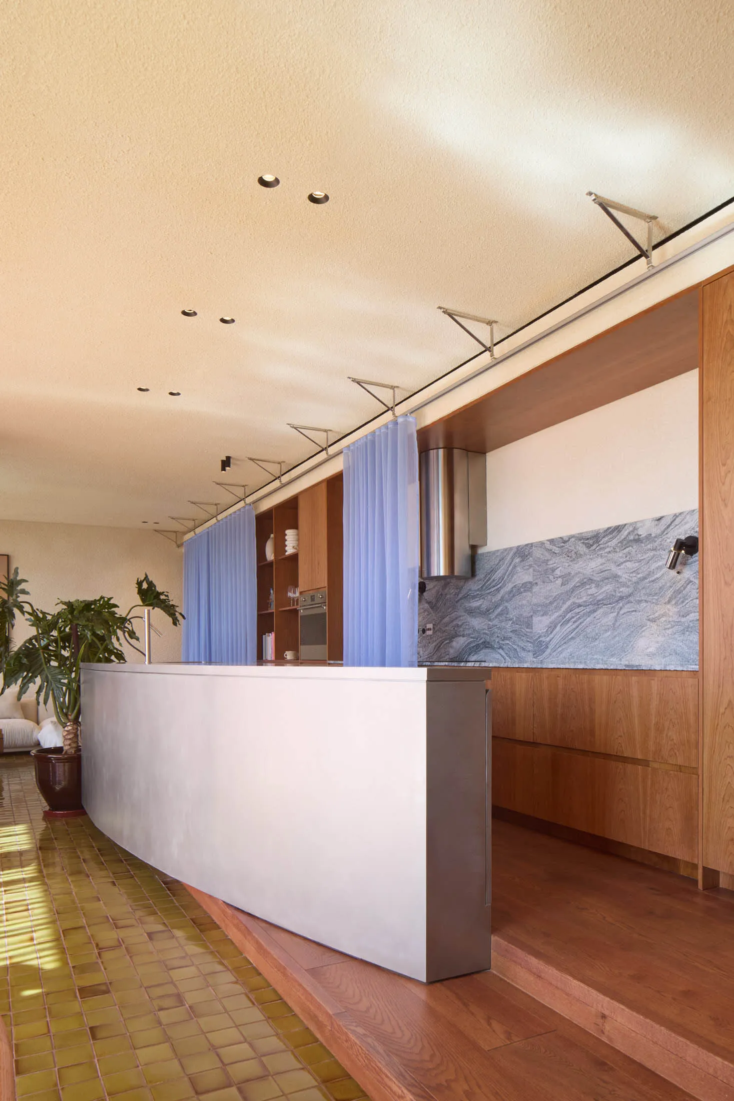 Modern kitchen with concrete countertops and wooden cabinets
