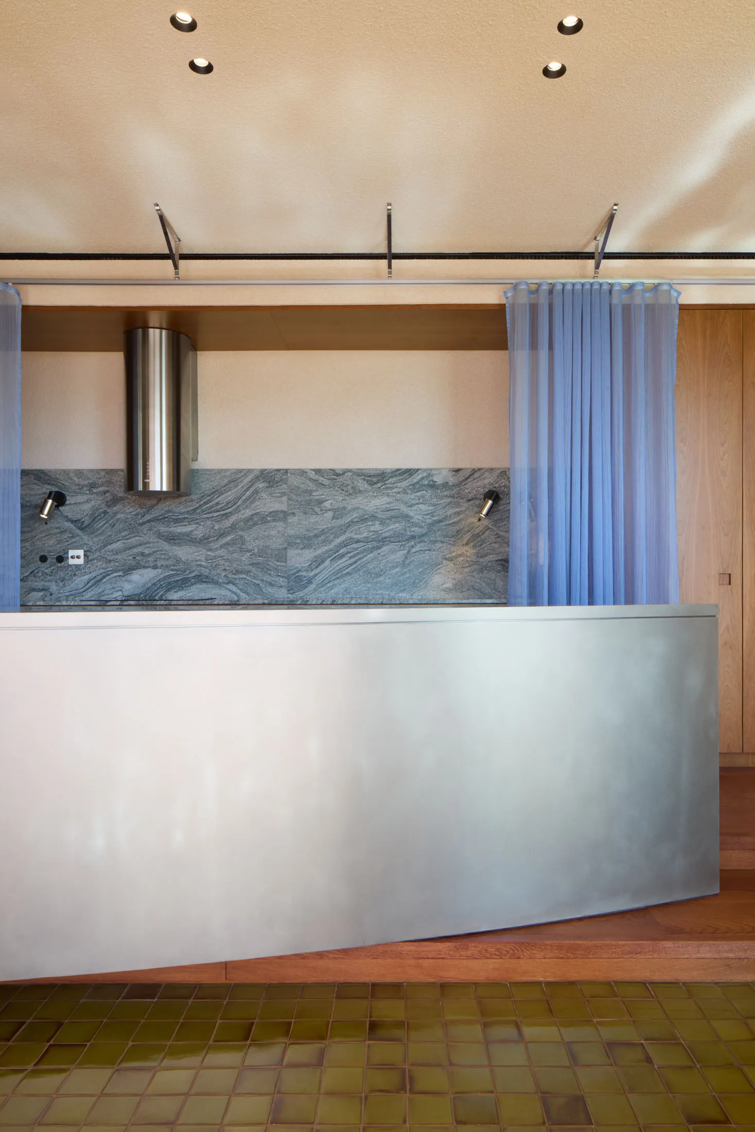A modern interior design featuring stainless steel and granite materials.