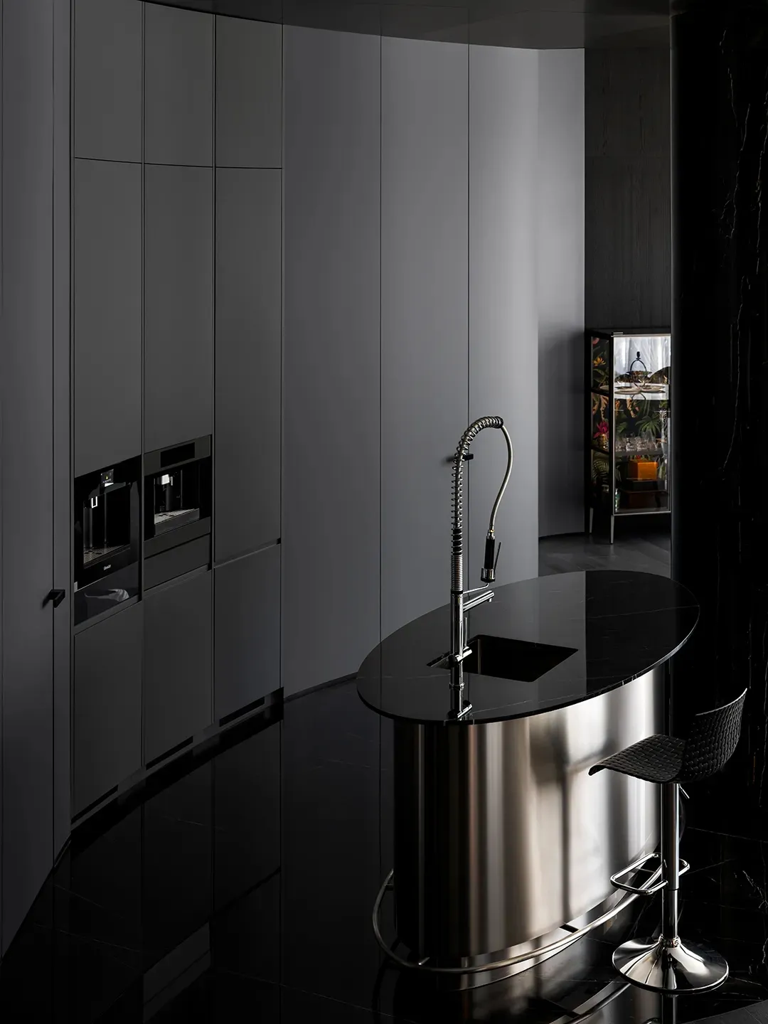 A modern kitchen featuring metal and marble finishes.