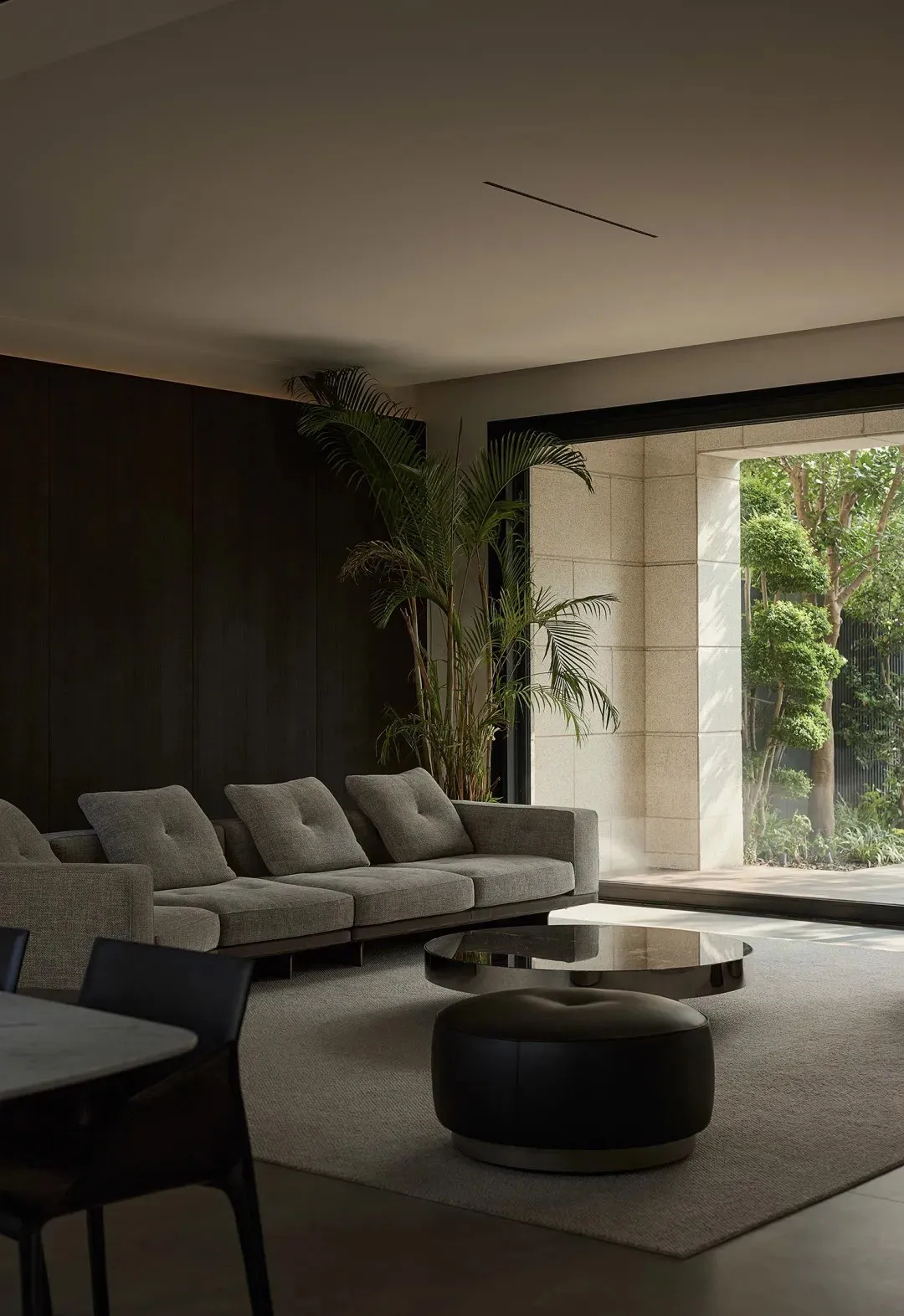 Modern living room featuring wood, concrete, and leather materials.