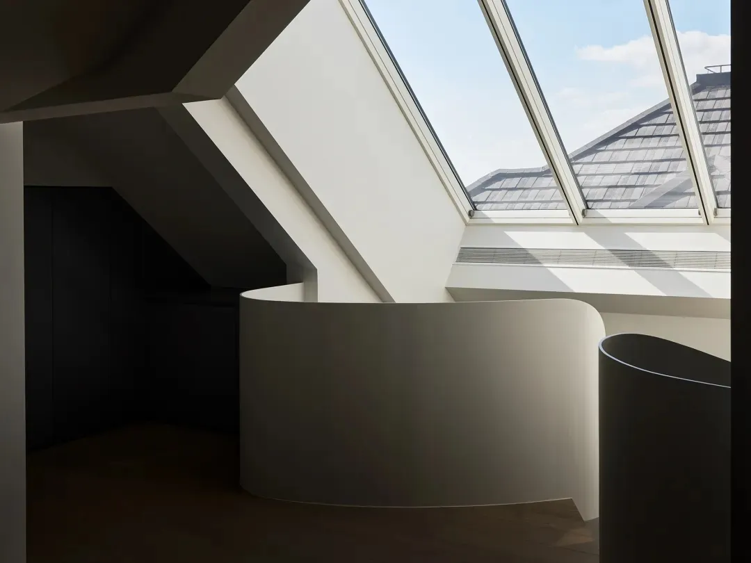 Modern loft interior with white concrete walls and skylight
