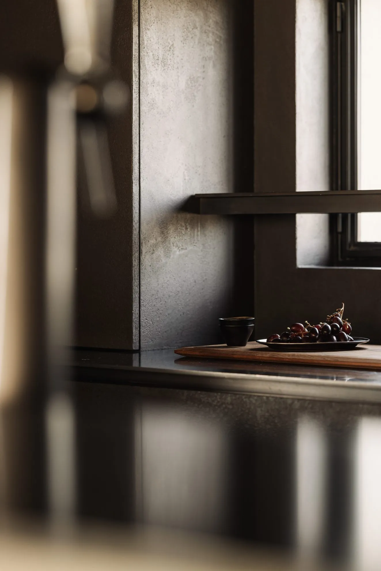 A minimalist kitchen with grey stone countertops