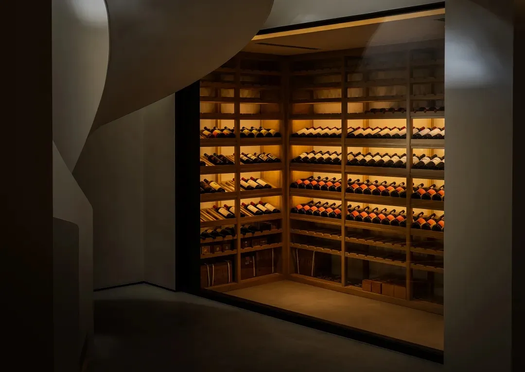 Modern minimalist wine cellar featuring wooden shelves and lighting