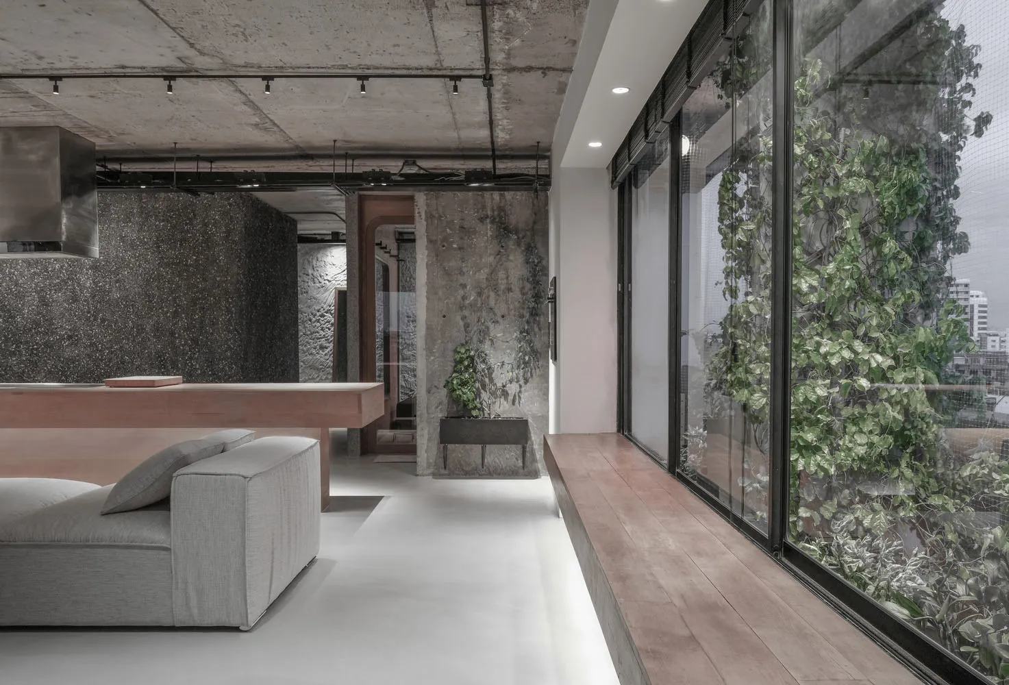 A modern-industrial living room with greenery and concrete wood materials, featuring a contemporary interior design with mini