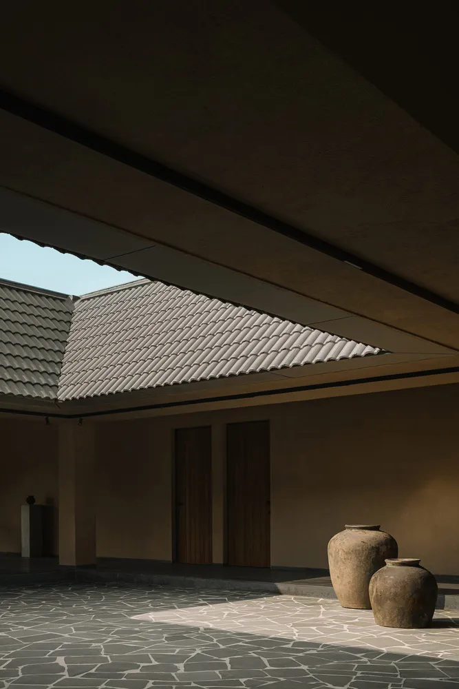 Modern interior space with tiled flooring and geometric roof structure
