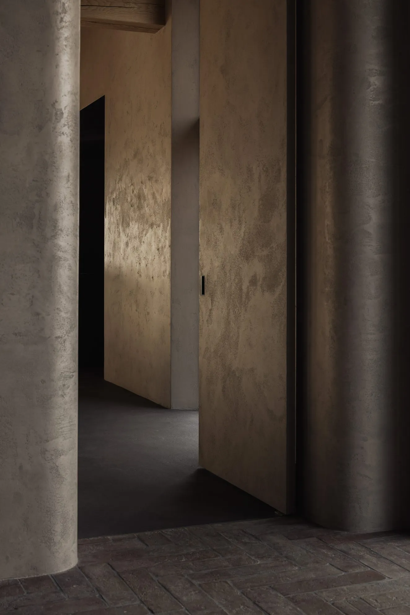 A modern, minimalist interior space with concrete walls and flooring.