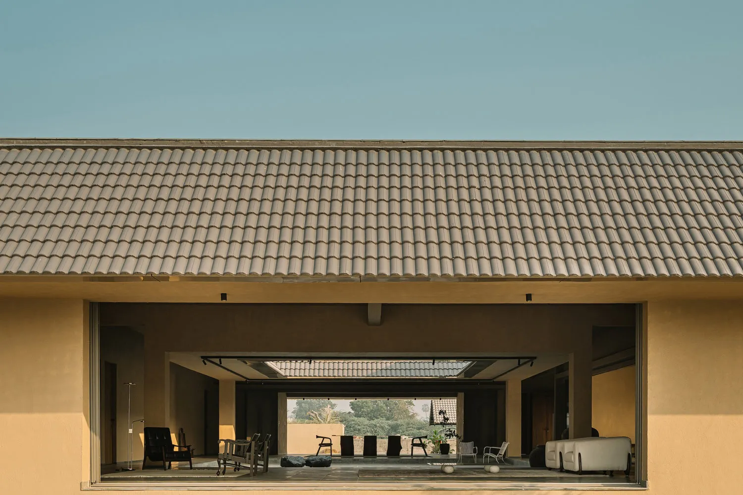 A modern building exterior with a terrazzo-tiled rooftop, large windows, and a spacious outdoor area.