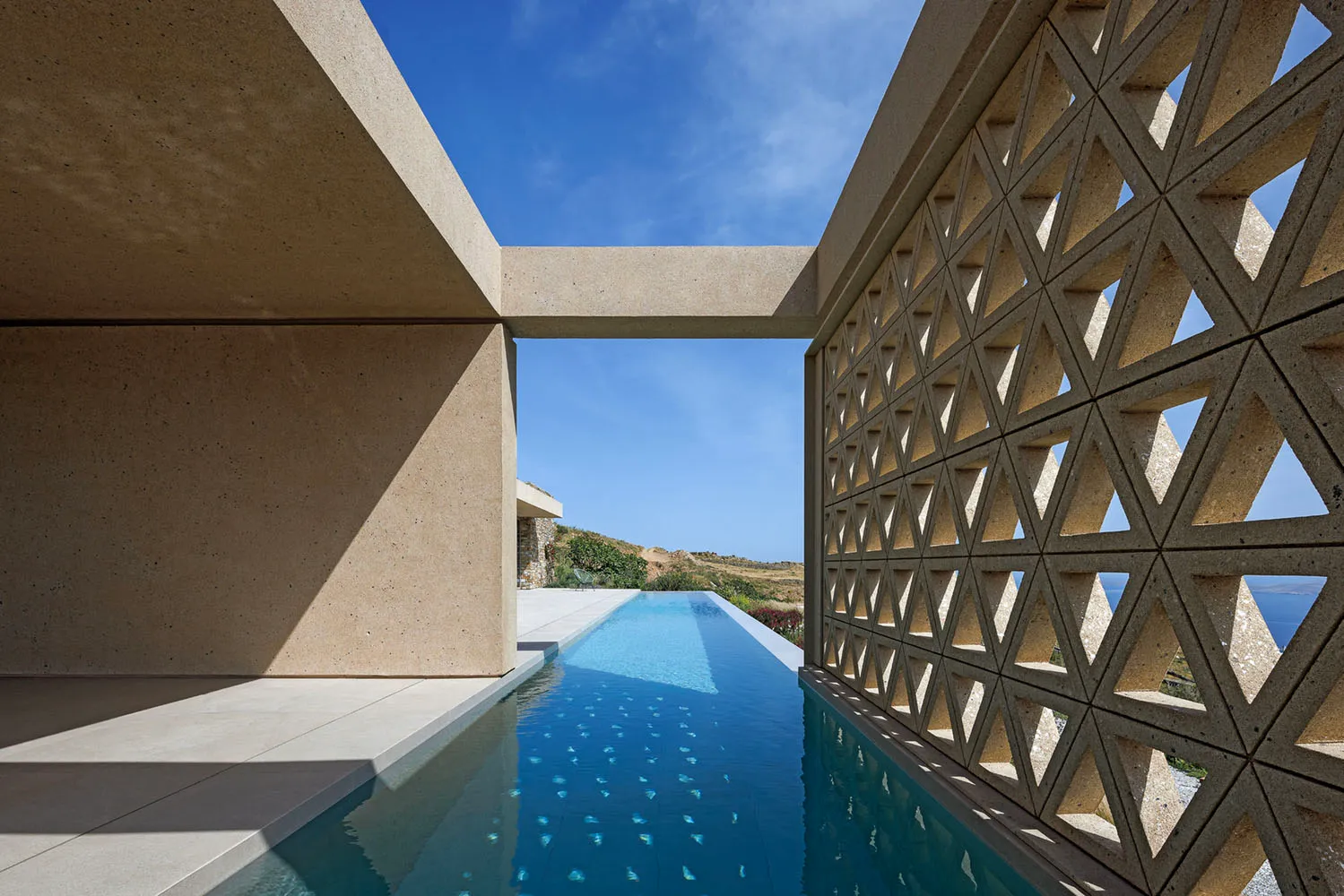 Modern swimming pool constructed of concrete with a geometric design.