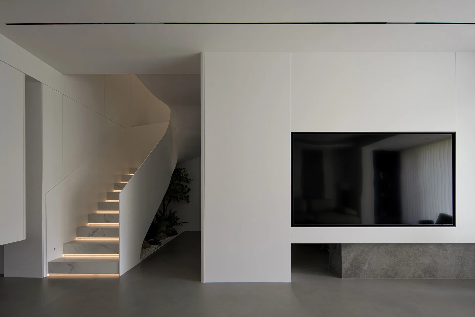 A contemporary minimalist living room with a concrete floor and modern design elements.