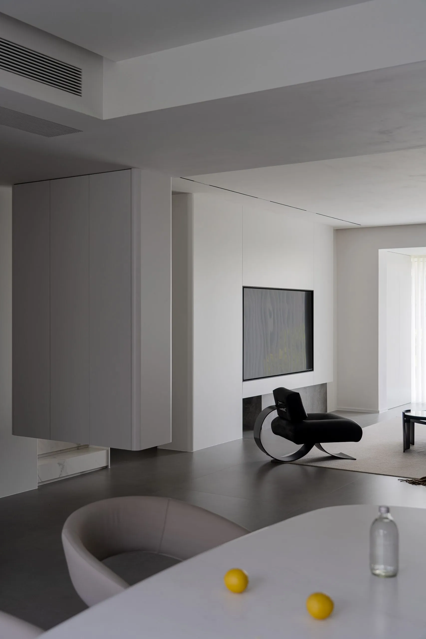 Modern minimalist living room featuring concrete, glass, and steel materials.