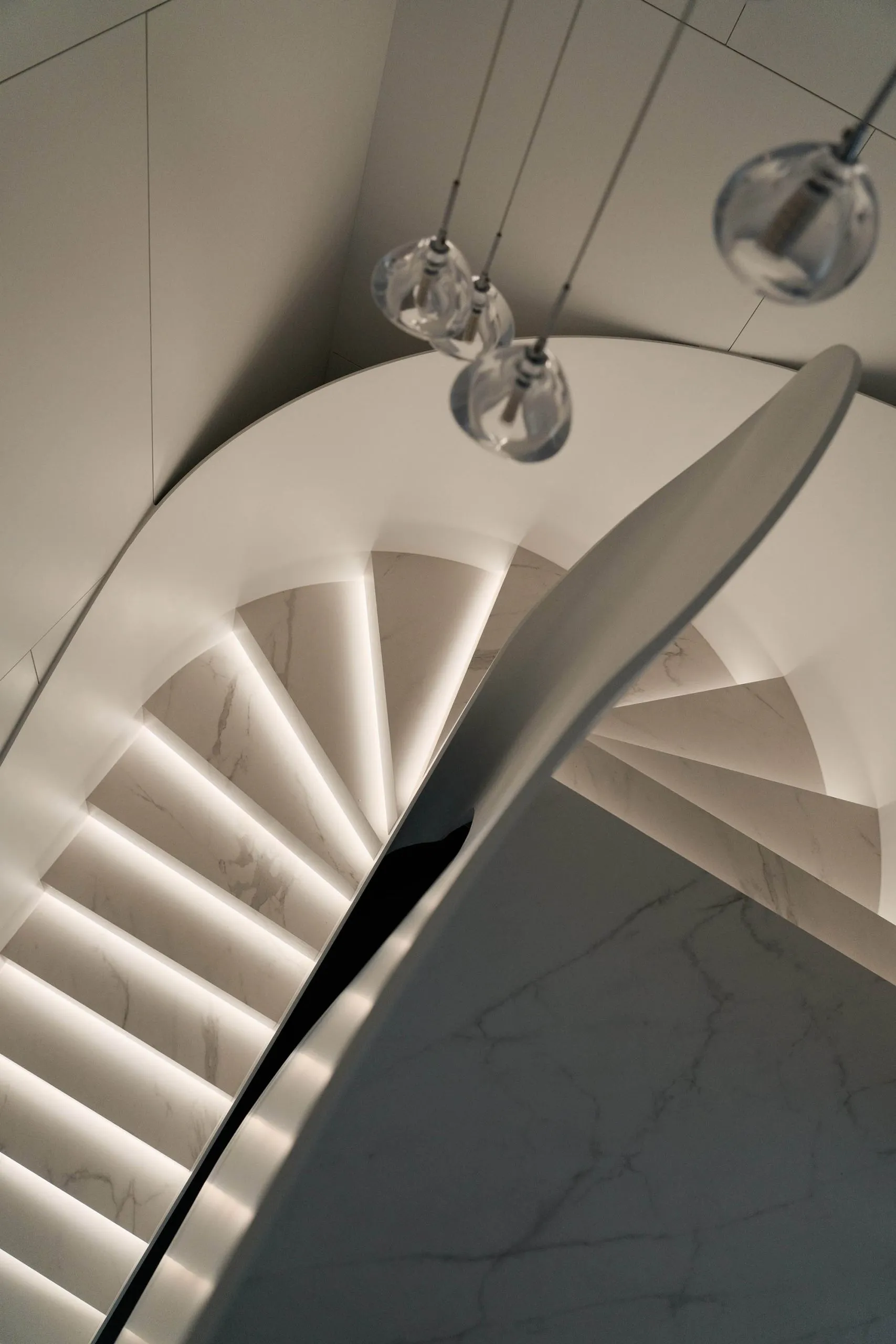 Contemporary staircase with marble steps and illuminated risers