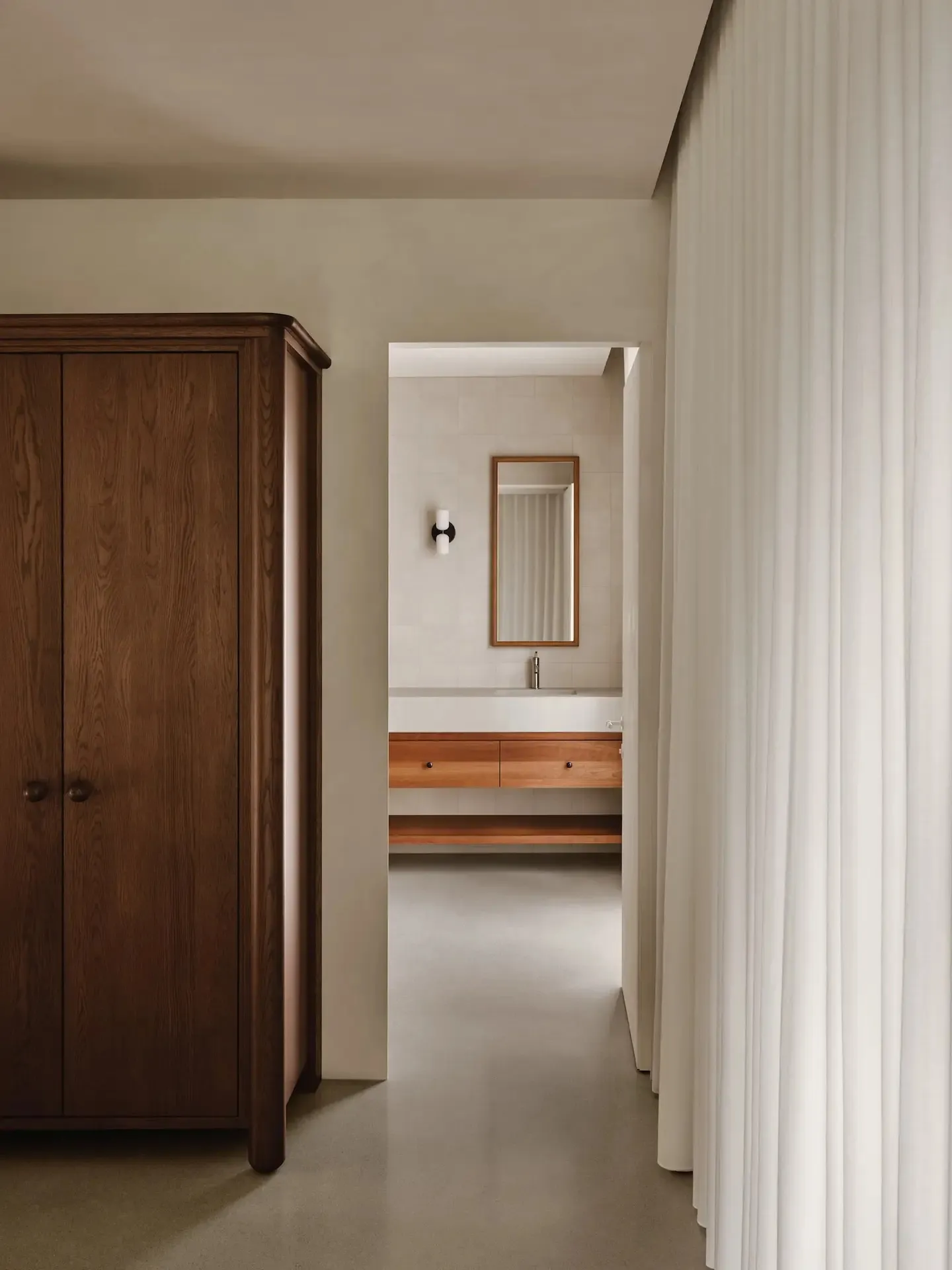 Minimalist bathroom with concrete walls and wooden vanity