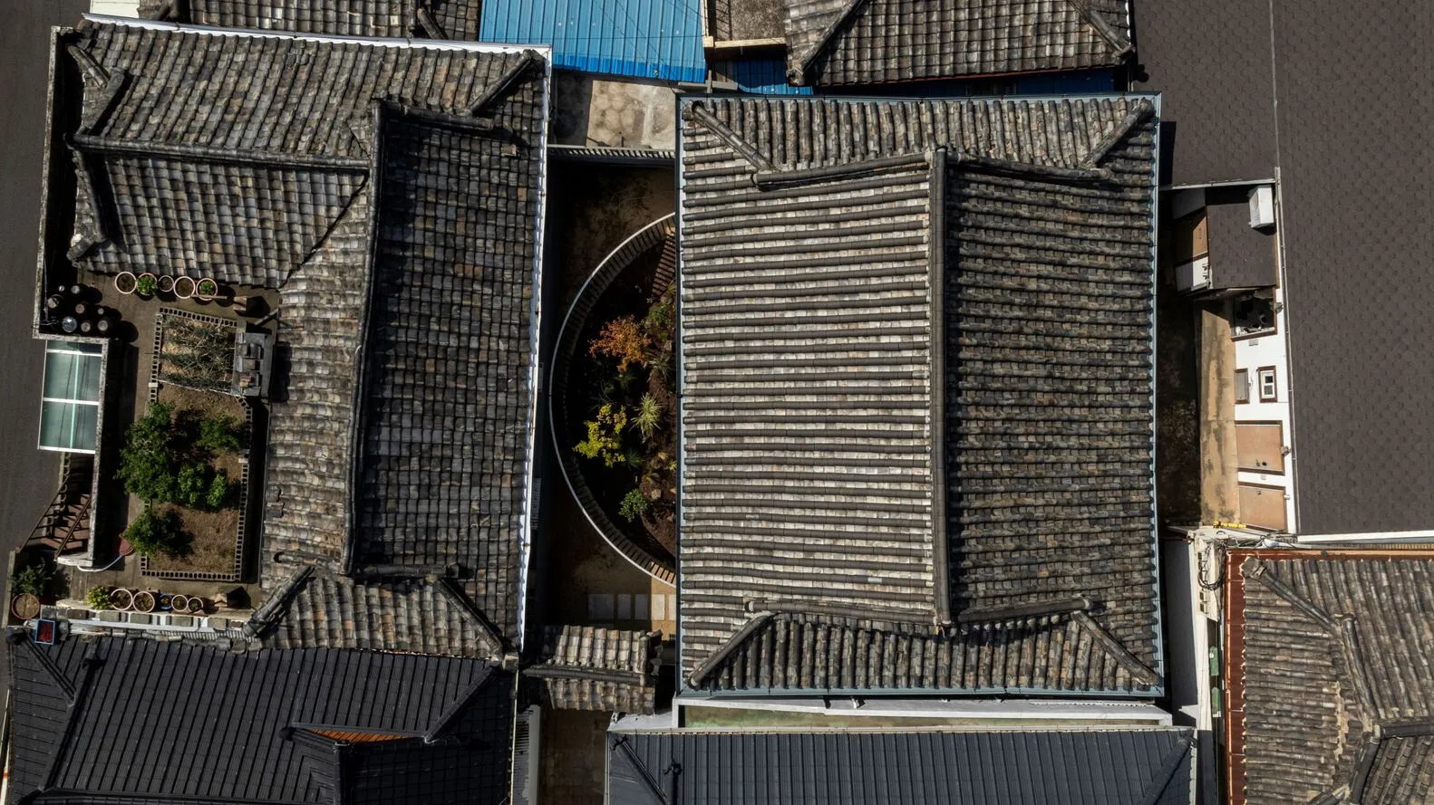 Aerial view of a rooftop garden with traditional tile roofing.