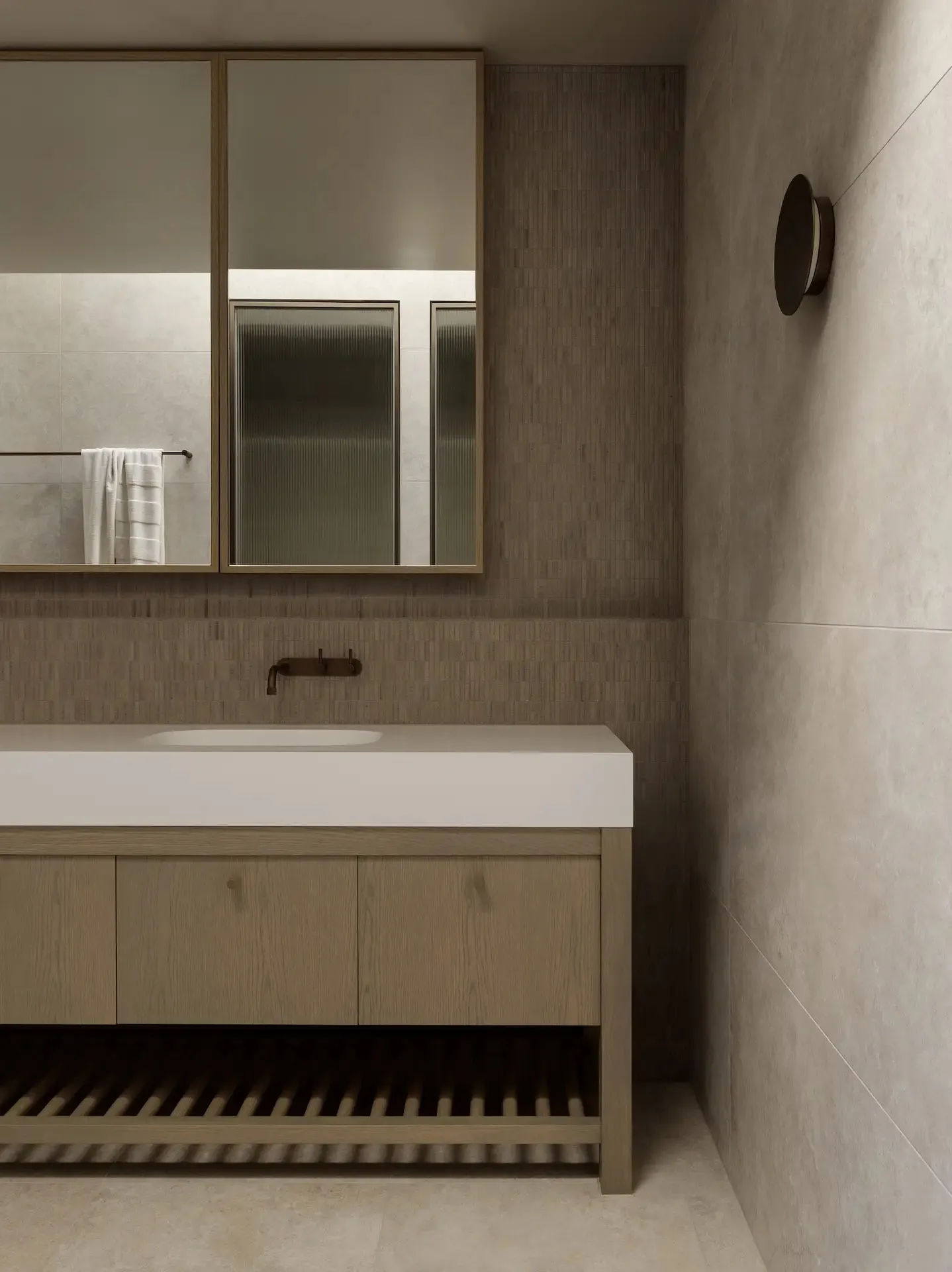 Minimalist bathroom with metallic fixtures and textured tiles