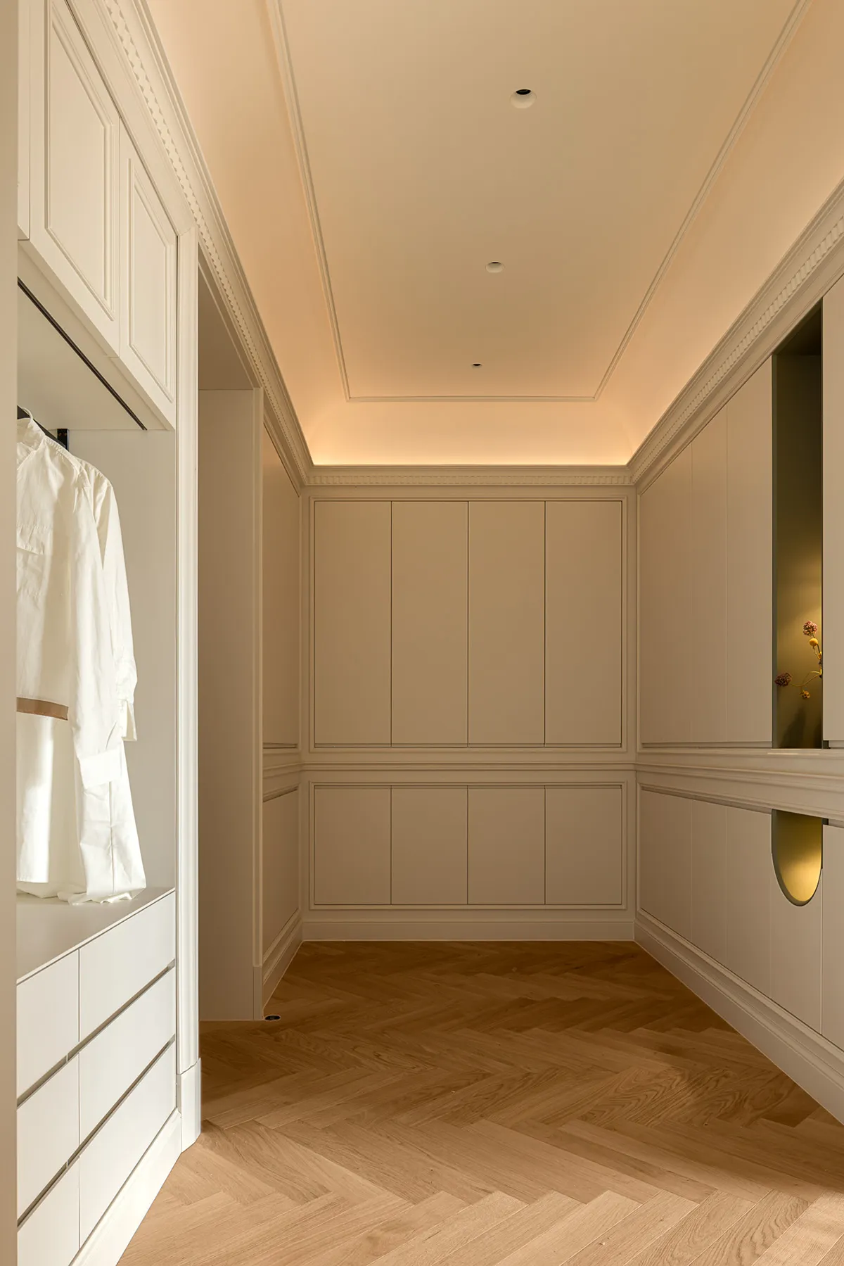 Modern minimalist closet with wooden paneling and built-in storage