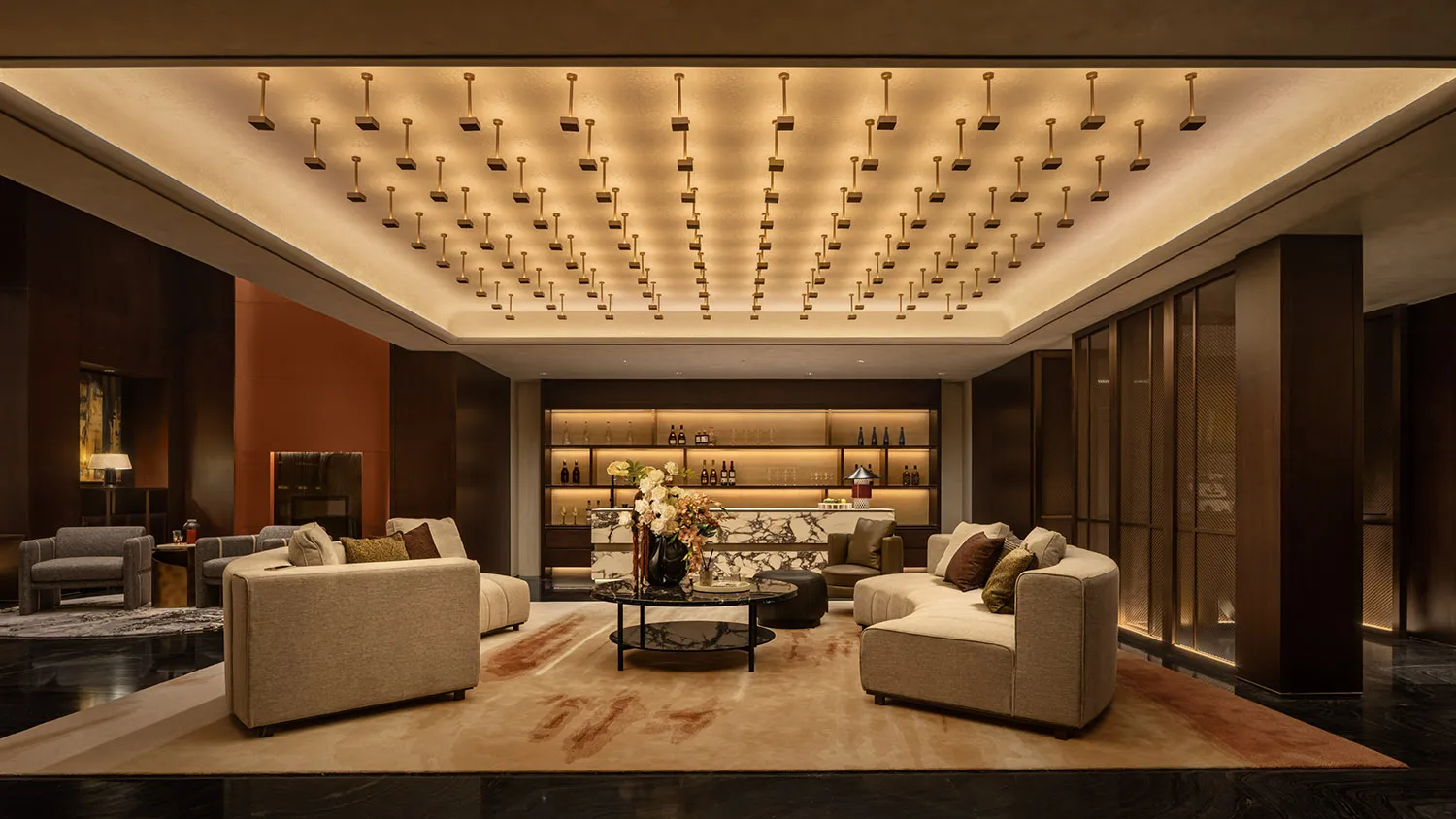Modern luxury hotel lobby with marble countertops, concrete accents, and luxurious seating arrangements.