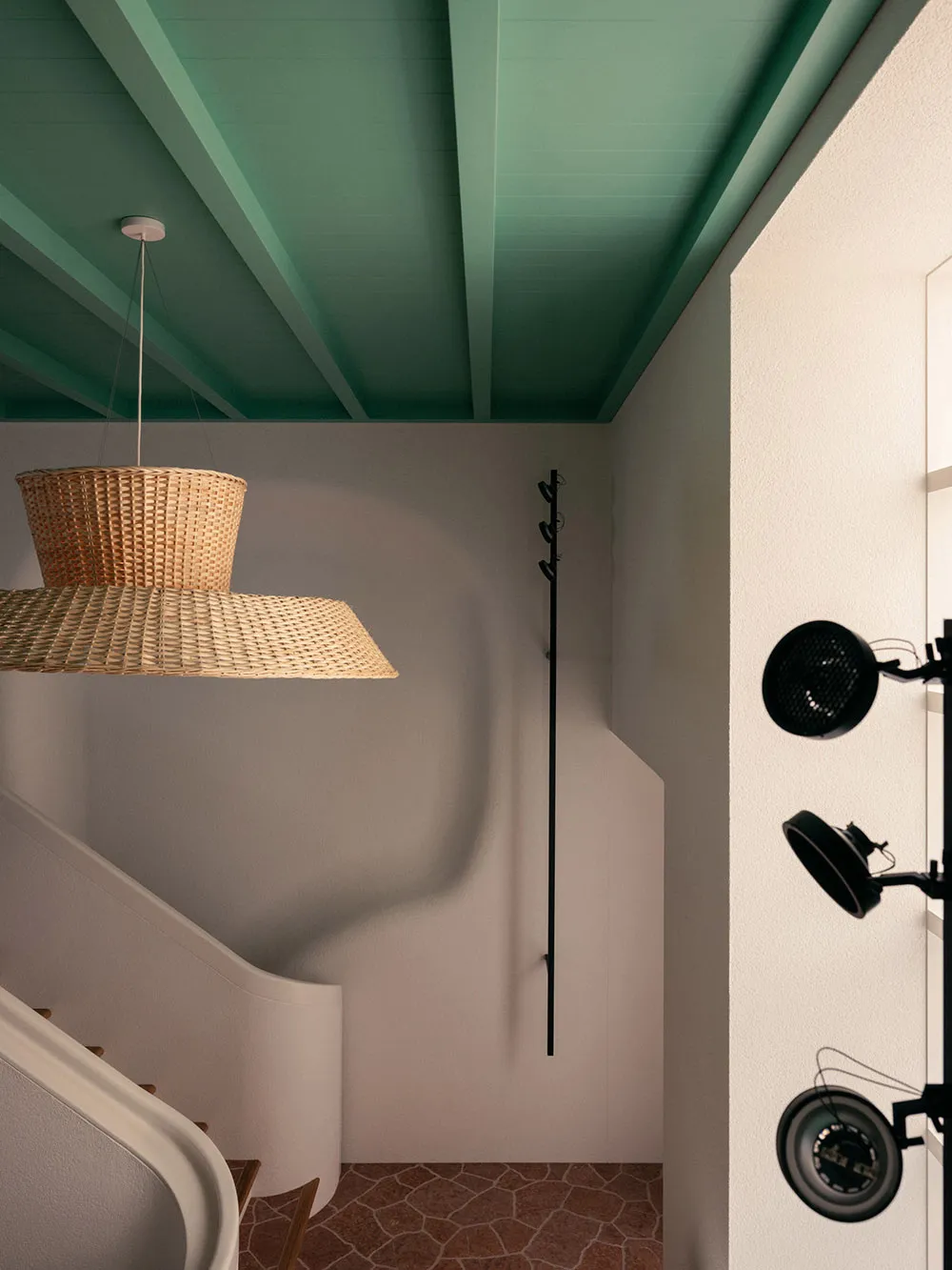 Woven lighting fixture hanging from a green wooden staircase with concrete steps.