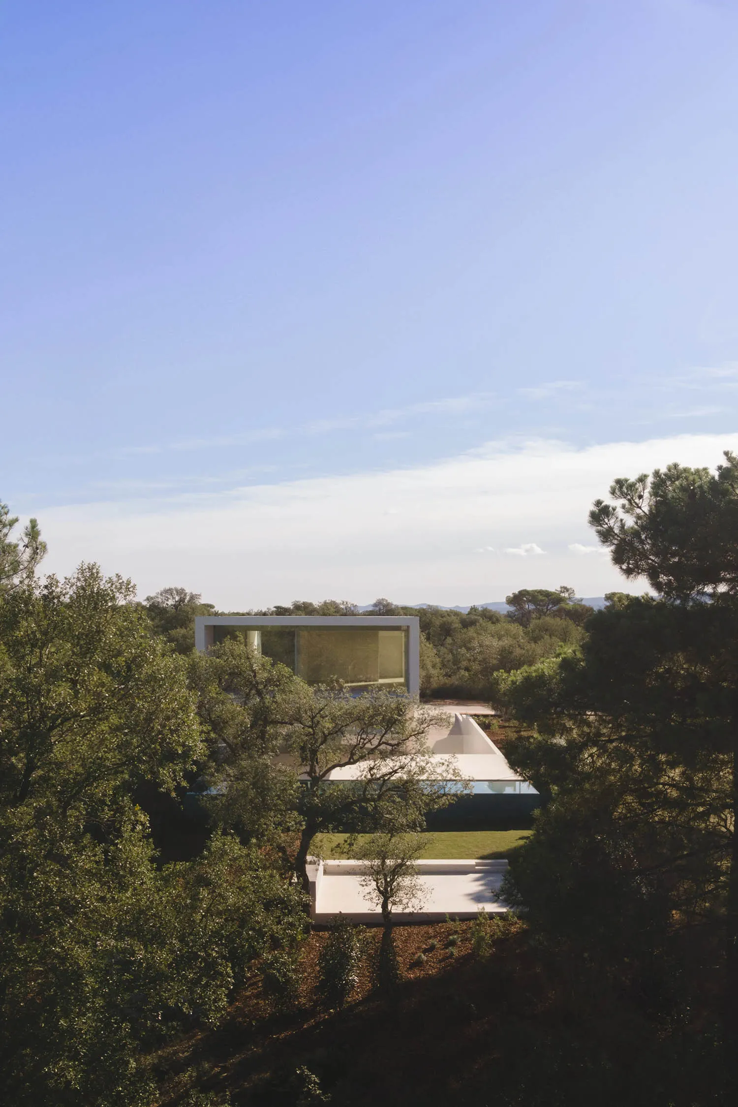 Modern house featuring glass and concrete materials, minimalist architectural style