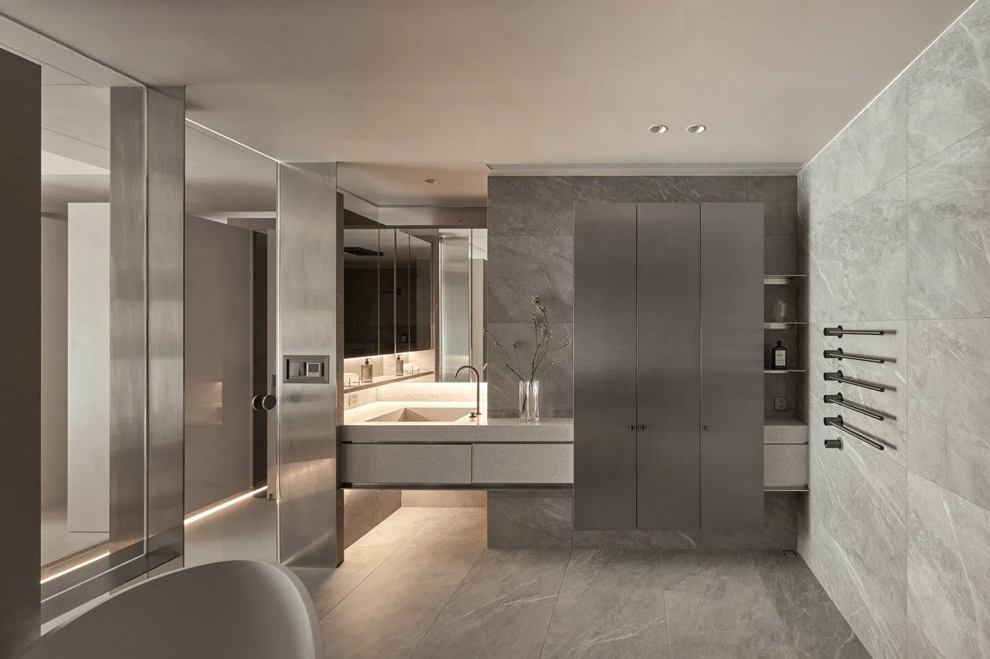 Contemporary minimalist bathroom with grey marble walls and floor, featuring a floating vanity and sleek, modern fixtures.