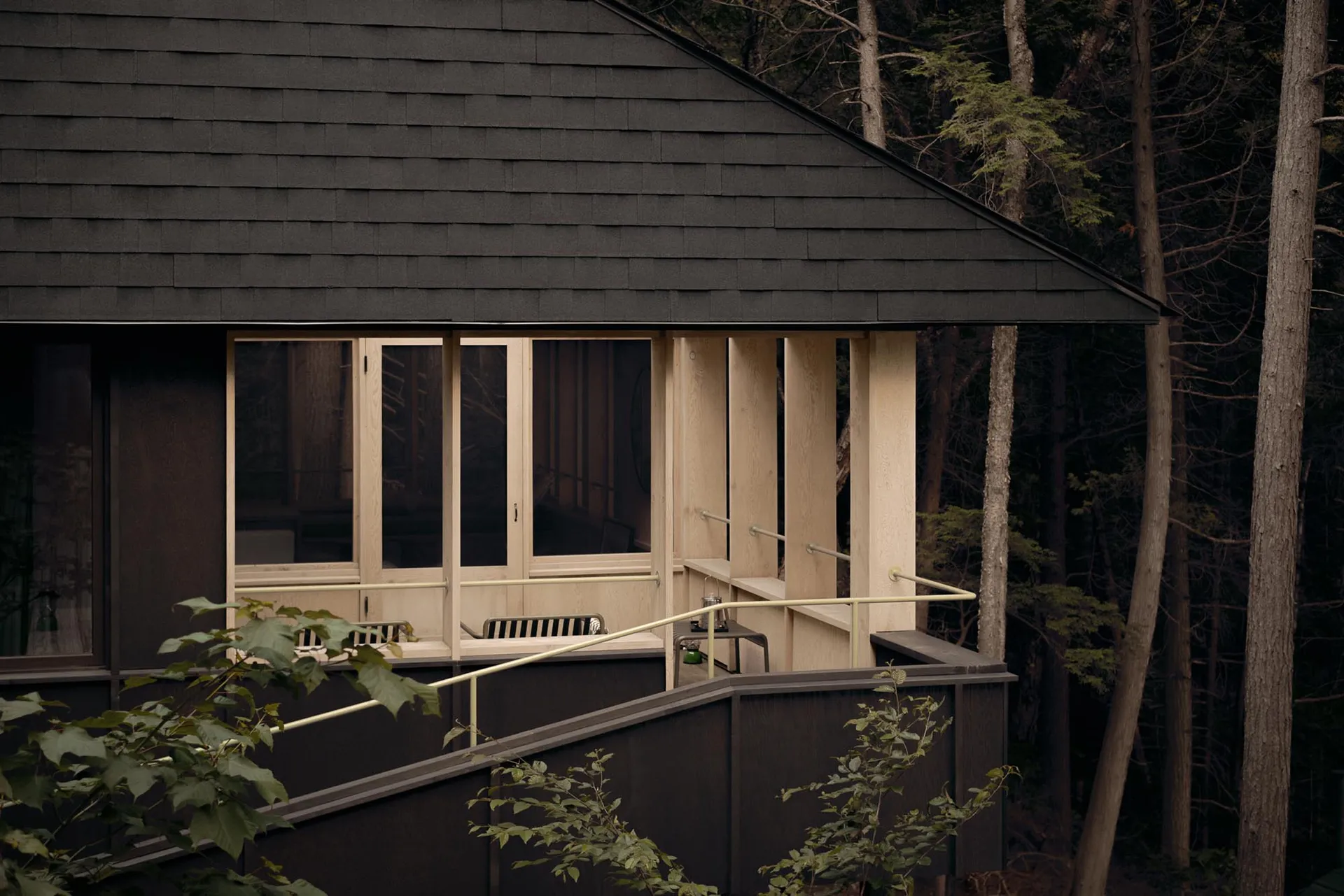 A minimalist residential porch with wooden elements and railing.