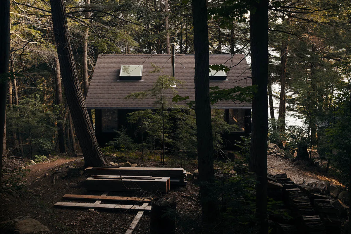 A modern house nestled in a wooded cityscape, featuring wood as its primary building material.