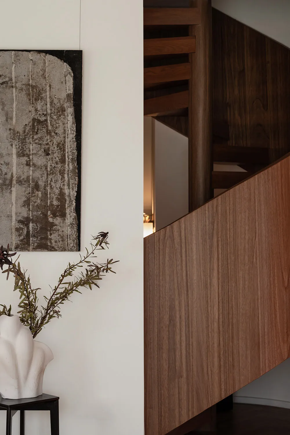 A modern interior staircase featuring wooden steps and railings.