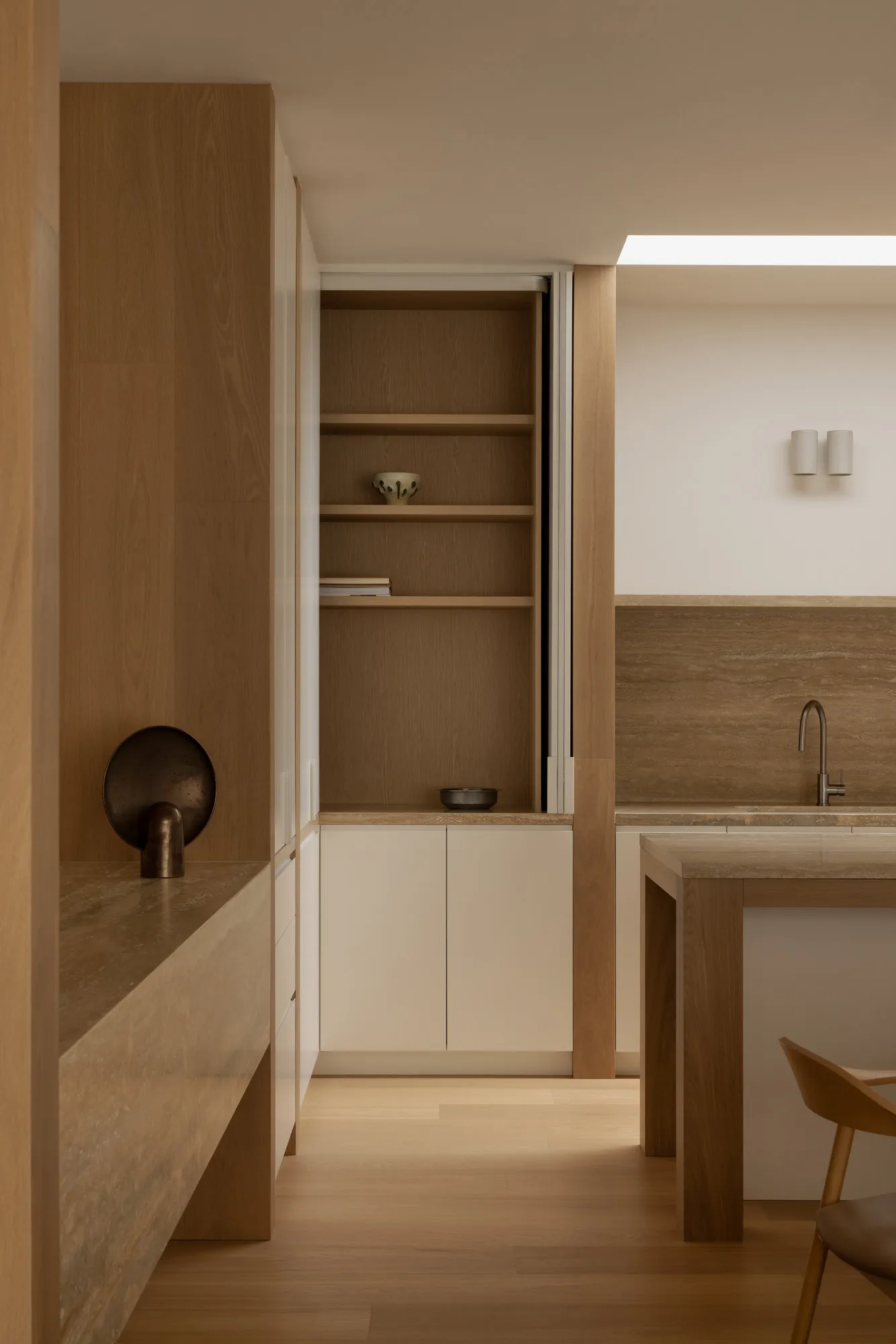 A modern minimalist kitchen featuring wood elements and a clean design.