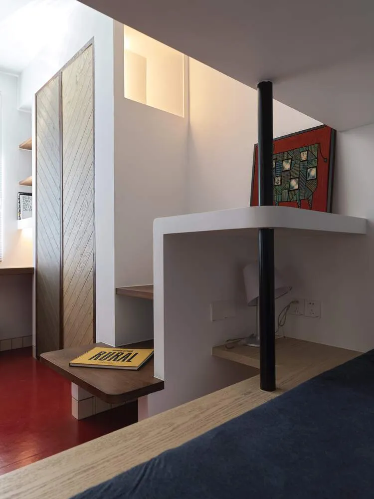A minimalist bedroom with wooden shelves, metal accents, and a wooden bed frame.