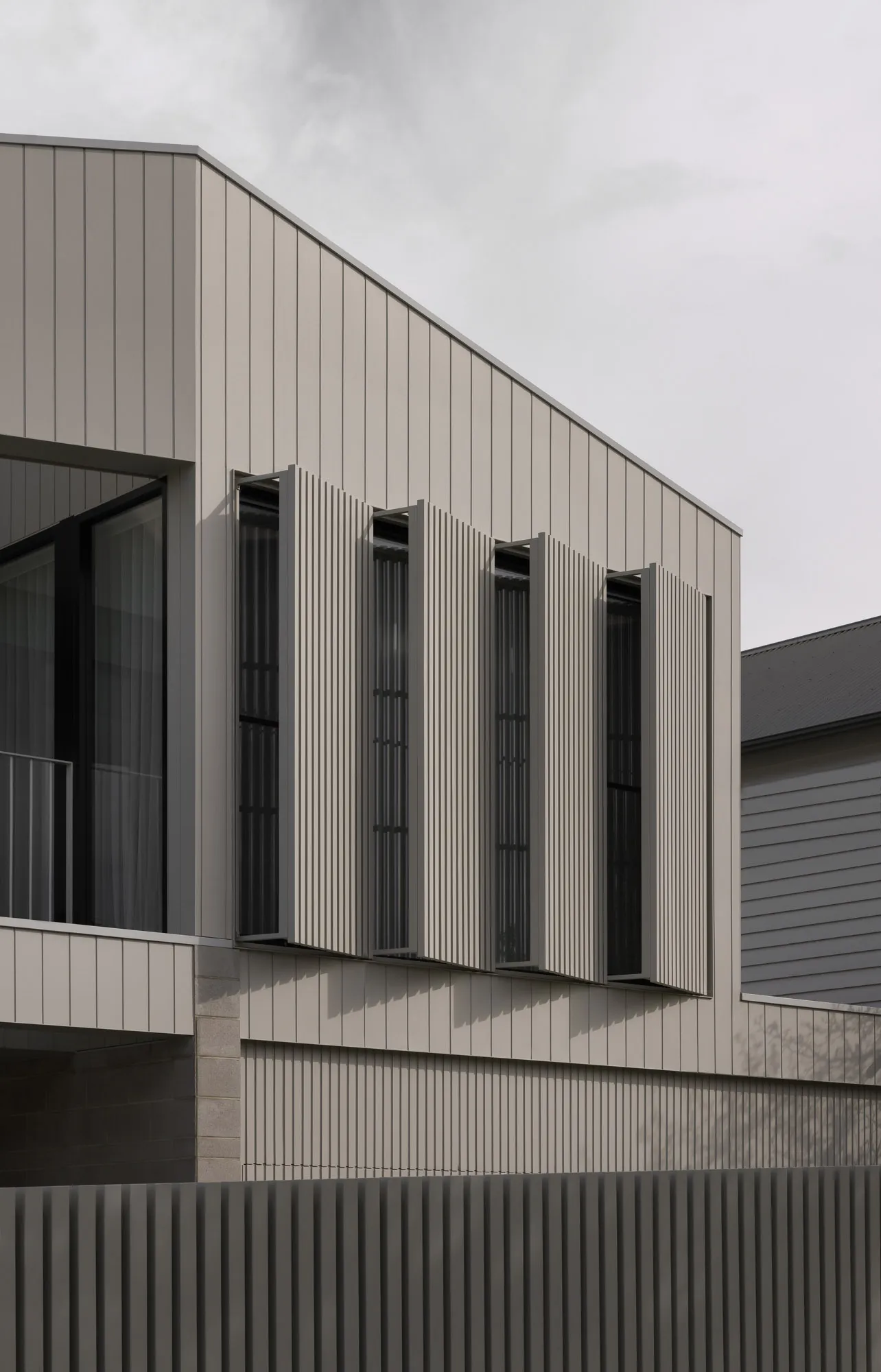Modern building facade featuring metallic cladding and vertical paneling