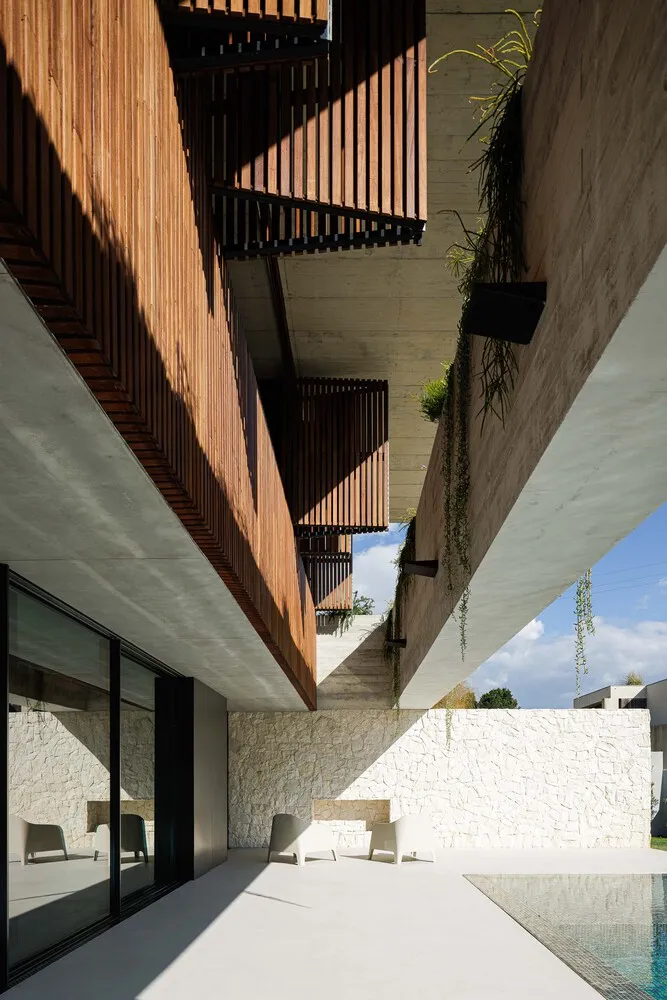 Contemporary residential architecture featuring wooden, concrete, and glass elements.