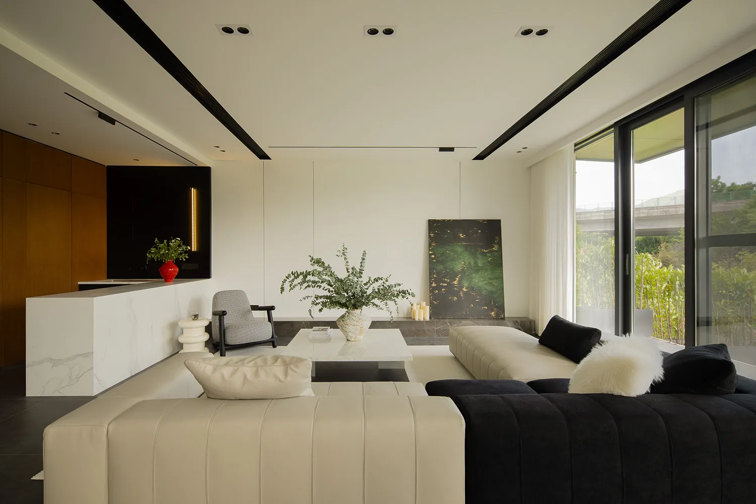 A modern living room featuring glass, marble, leather, and wool materials.