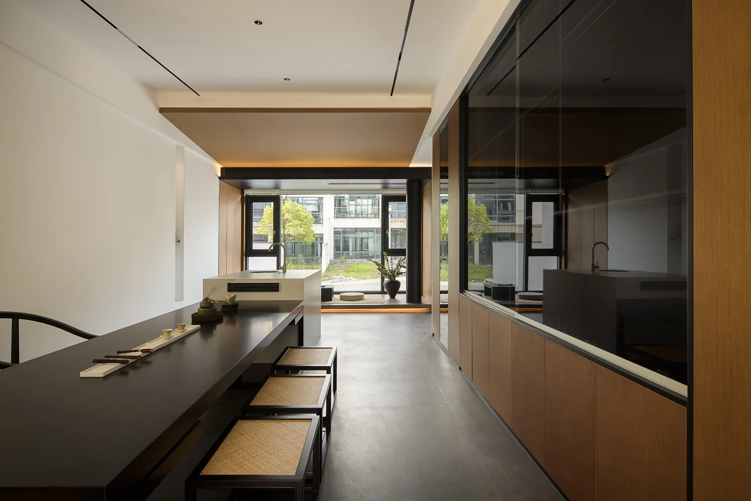 Modern residential kitchen featuring timber, glass, and stone elements.