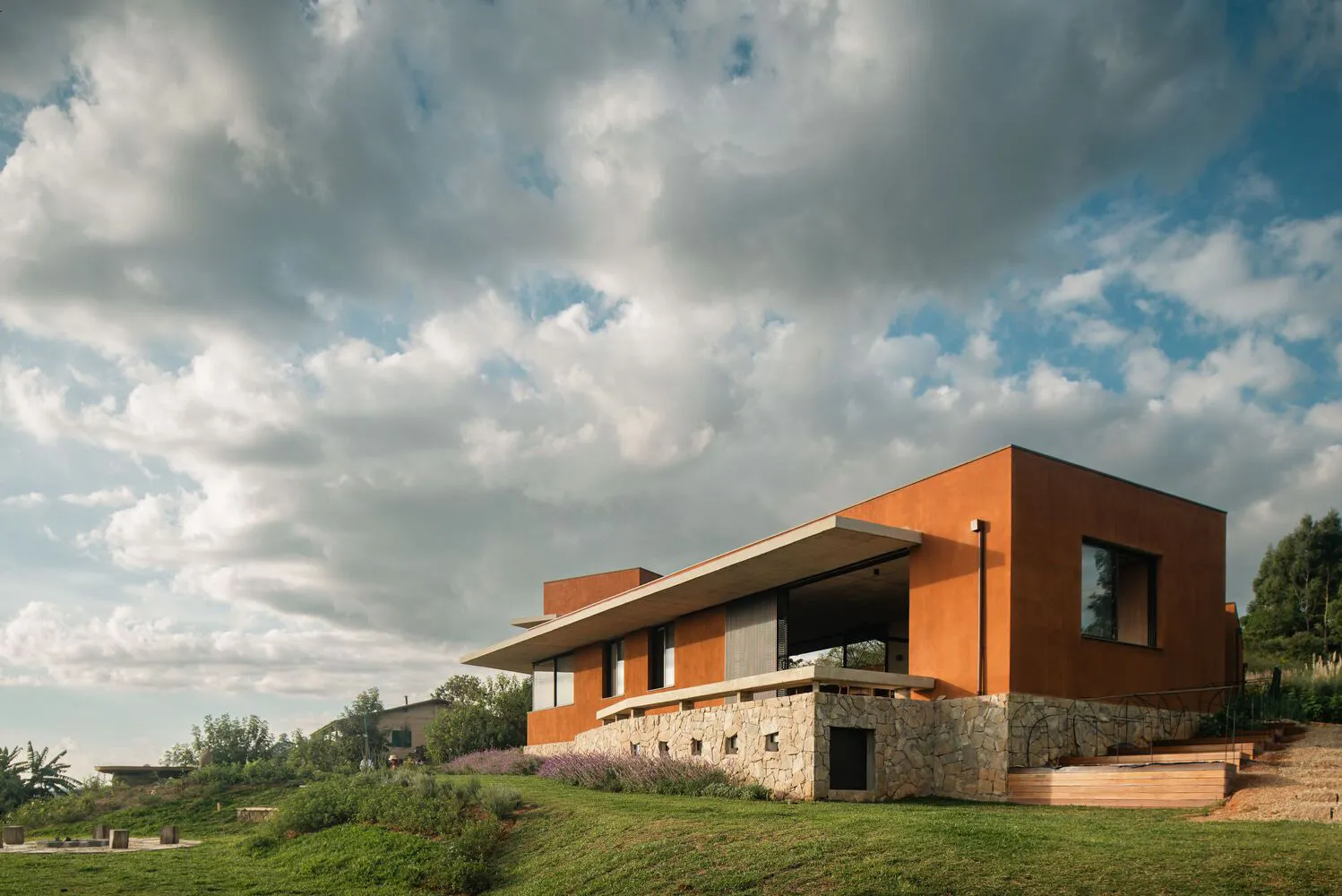 Modern house with stone and concrete exterior, featuring contemporary design and open spaces.