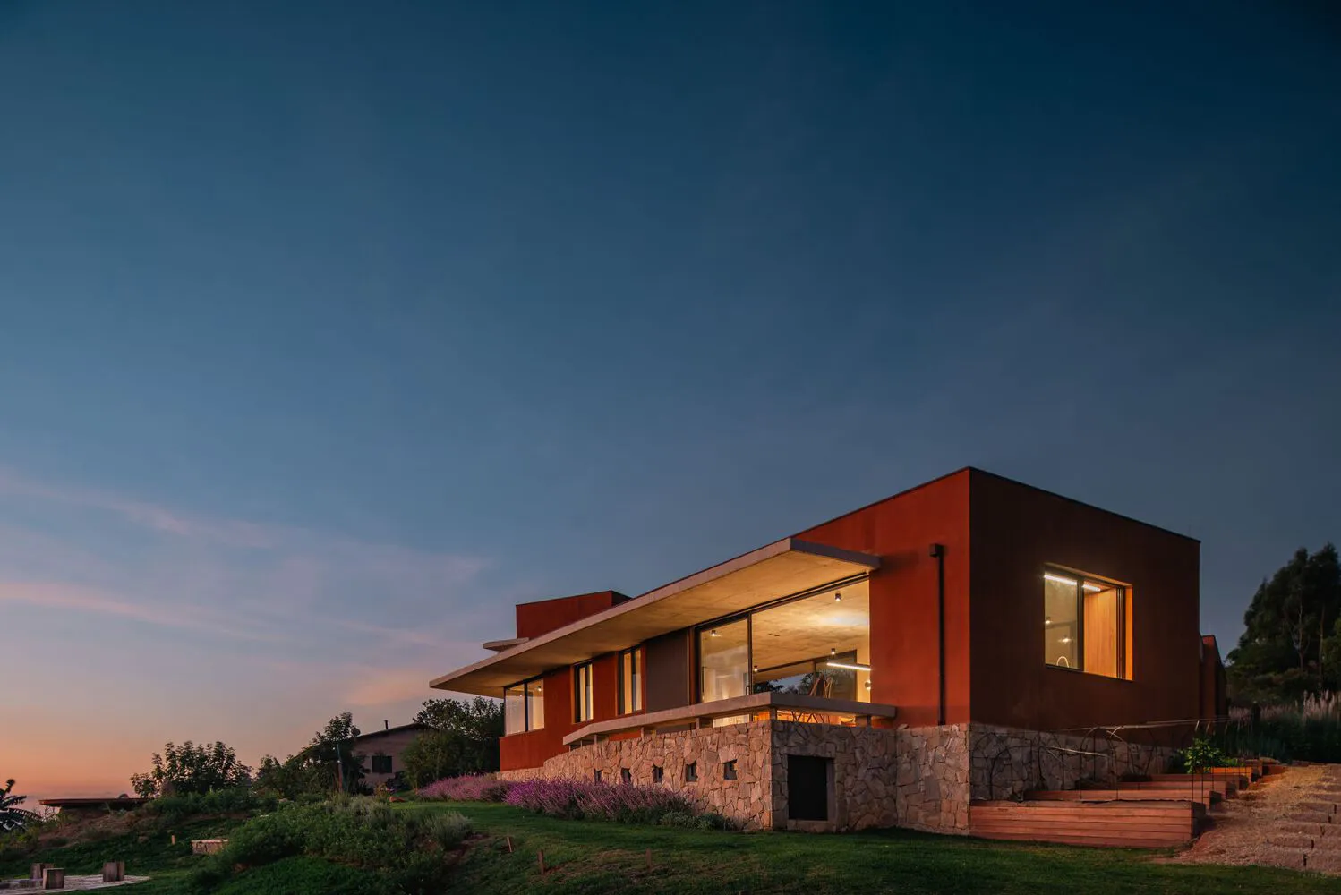 A modern residential house with clay bricks exterior during dusk.