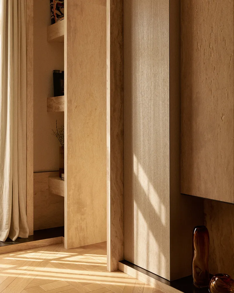 A minimalist interior design featuring wooden elements and a natural light source.