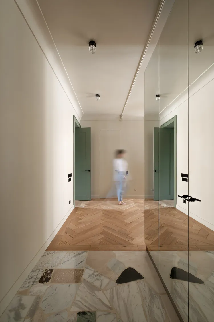 Modern residential interior with wooden and marble floor tiles.