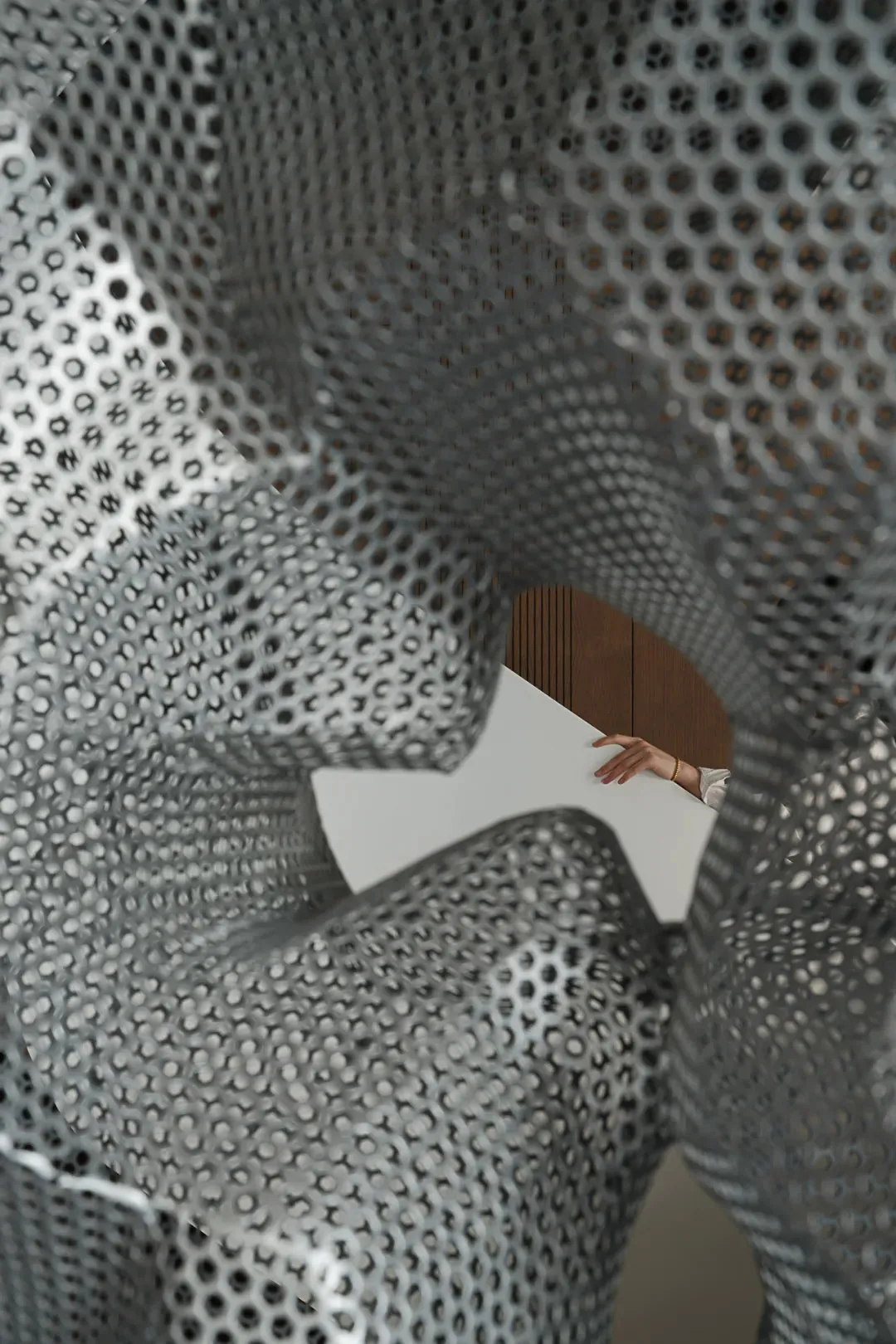 A modern interior design featuring metallic mesh material.