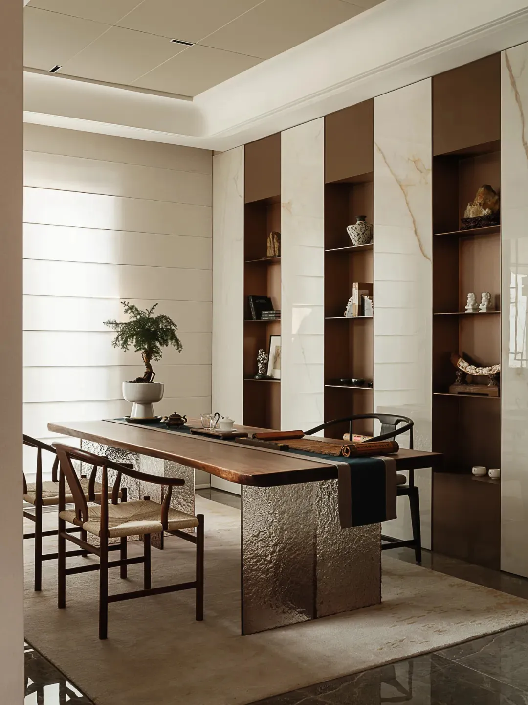 A modern study with a wooden table and marble columns.