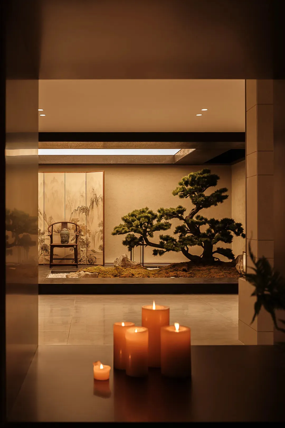 A minimalist interior space with a bonsai tree and ceramic elements, illuminated by candlelight.