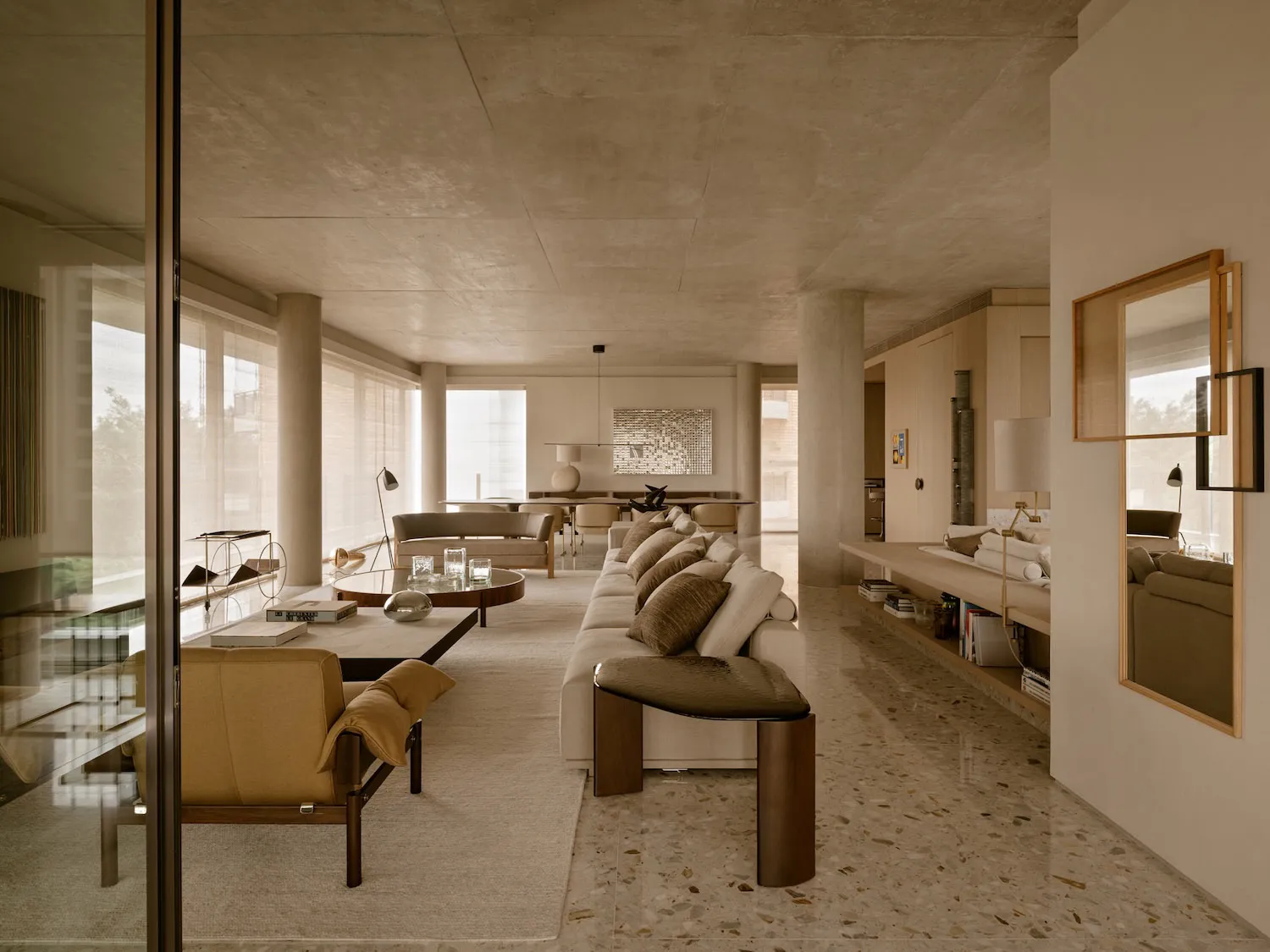Modern living room featuring terrazzo flooring and minimalist furniture.