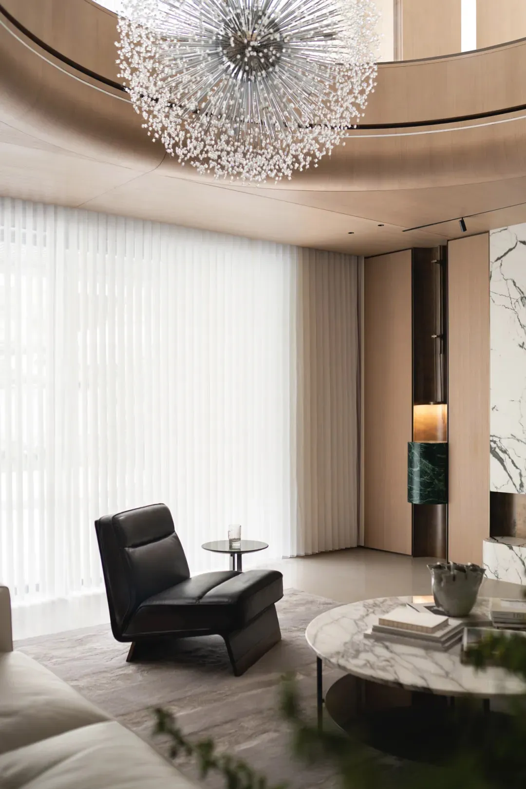 A modern minimalist lounge area featuring marble and glass elements.