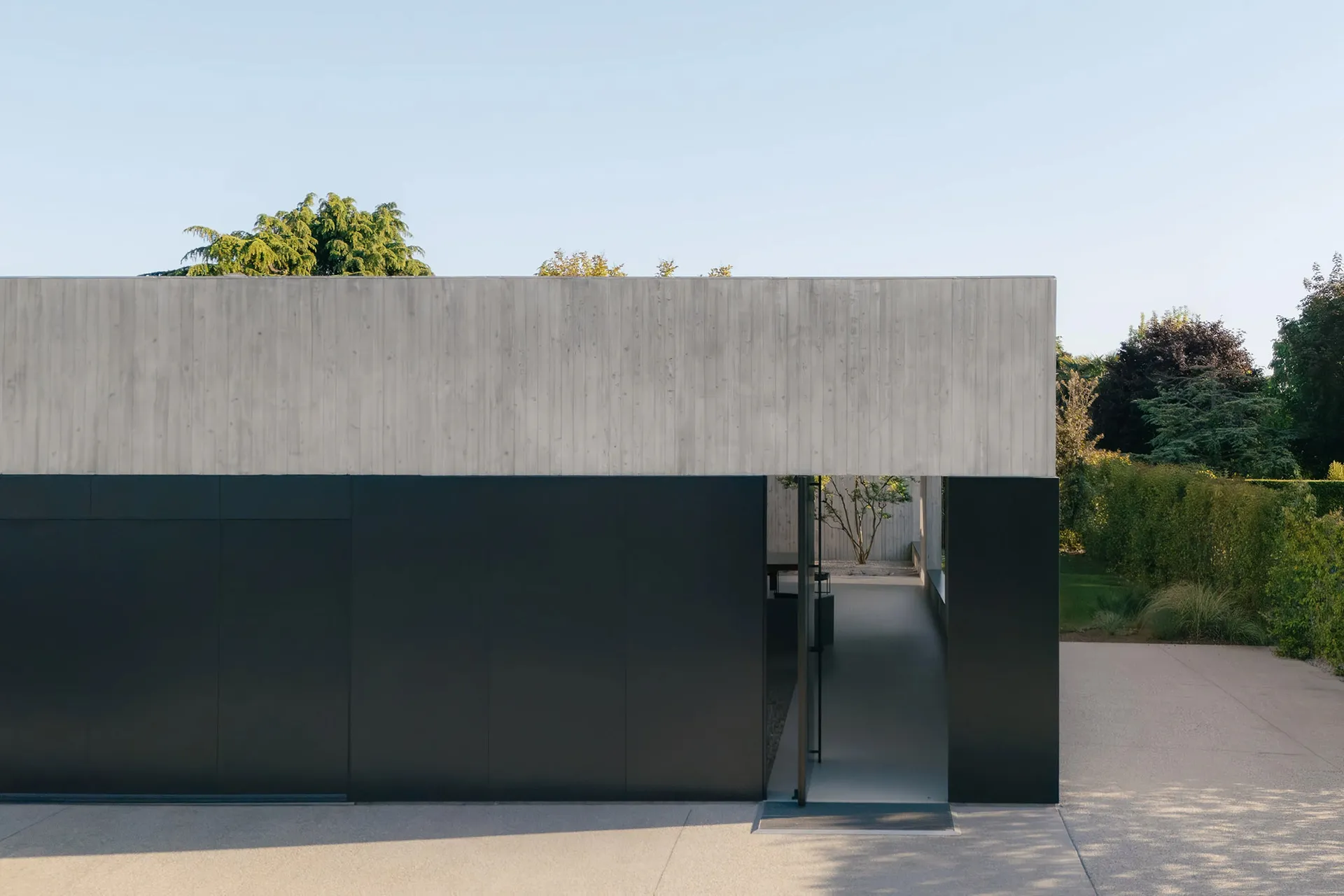 A modern residential building with a concrete and glass facade.