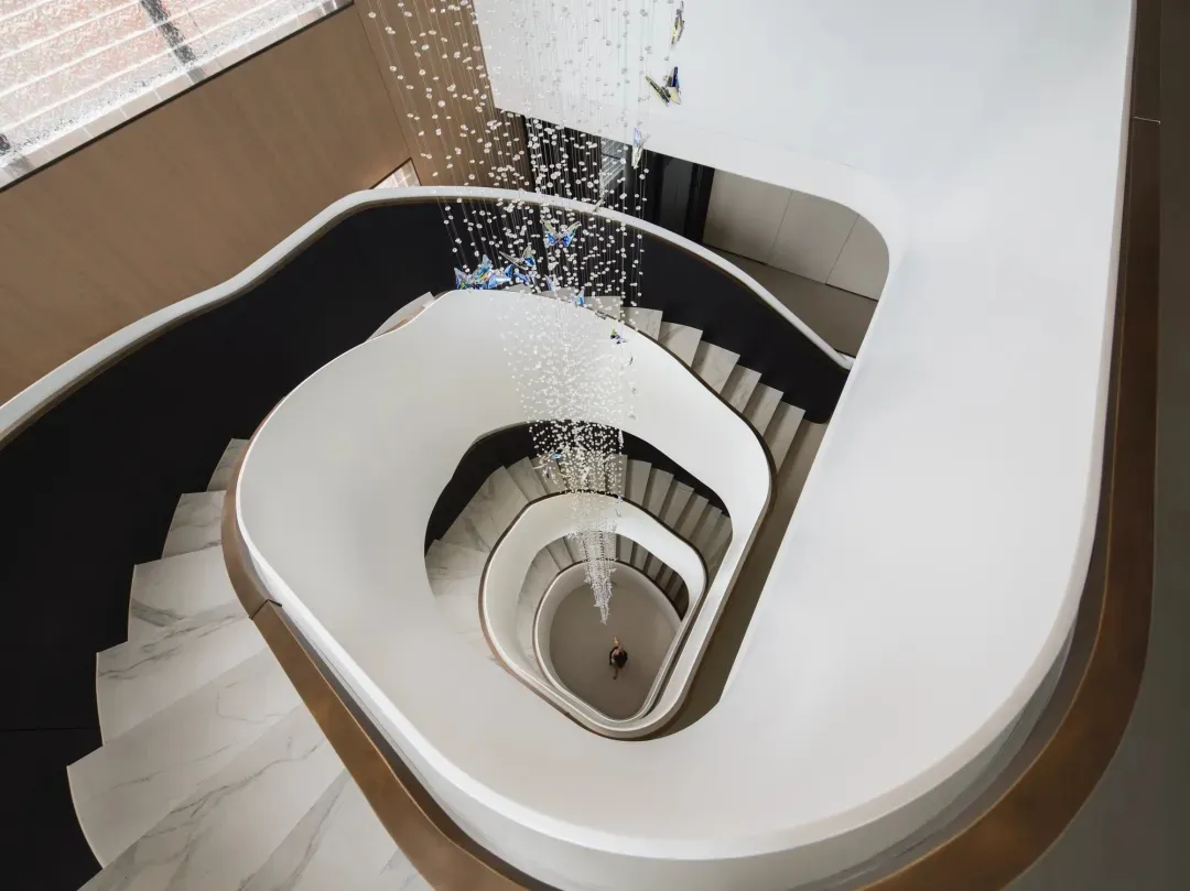 Staircase with modern design featuring marble material and decorative elements.