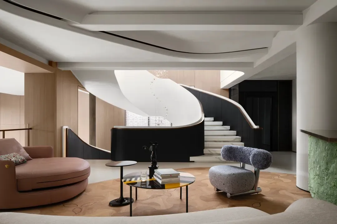 A well-designed modern interior living room featuring wooden panels, leather textiles, and marble flooring.