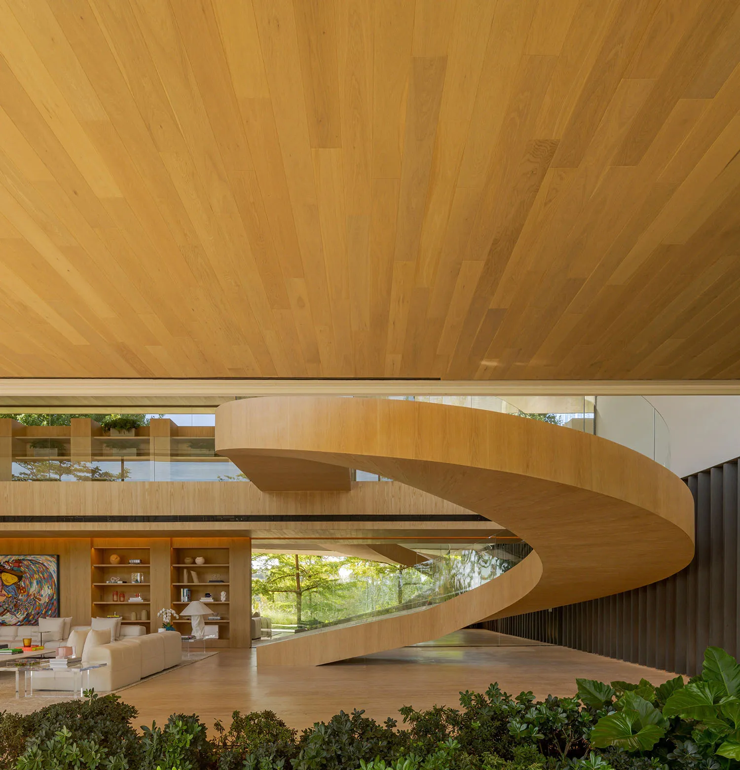 Interior design of a modern minimalist living room featuring a curved wooden staircase, extensive use of natural light, and a