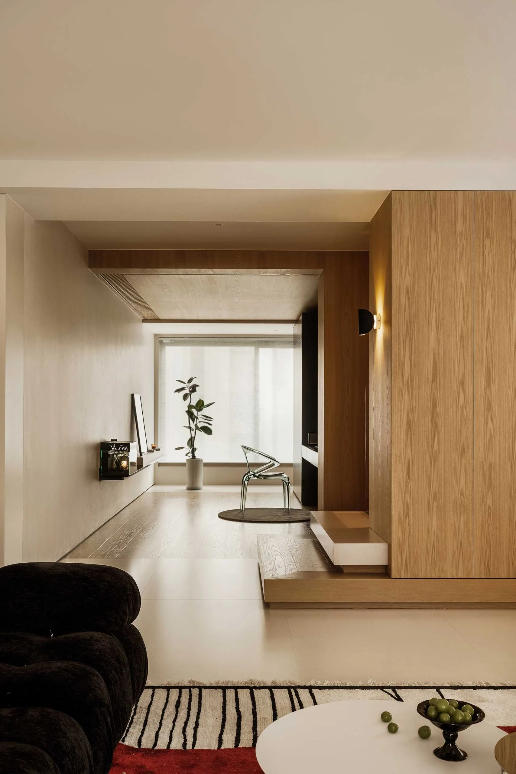 Modern living room featuring wooden finishes, metallic accents, and glass elements.