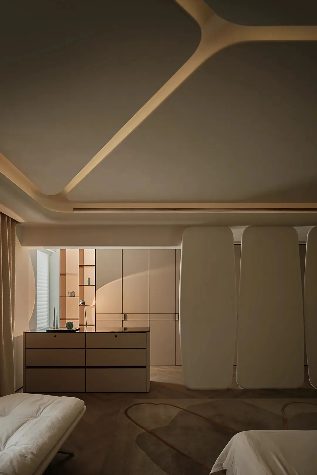 Contemporary bedroom interior with neutral-toned decor and minimalist design.